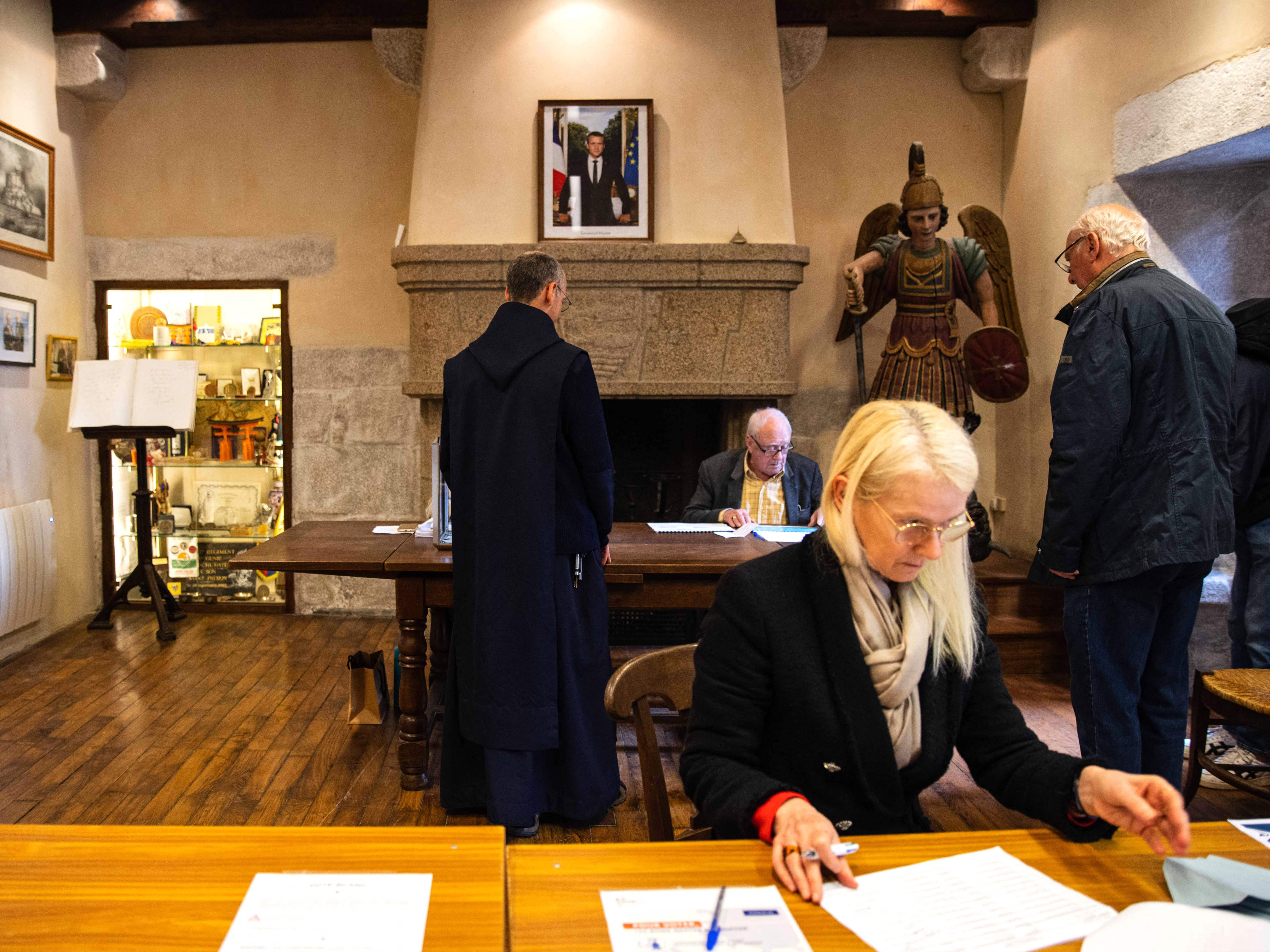 Officials work at a polling station in Le Mont-Saint-Michel, northwestern France