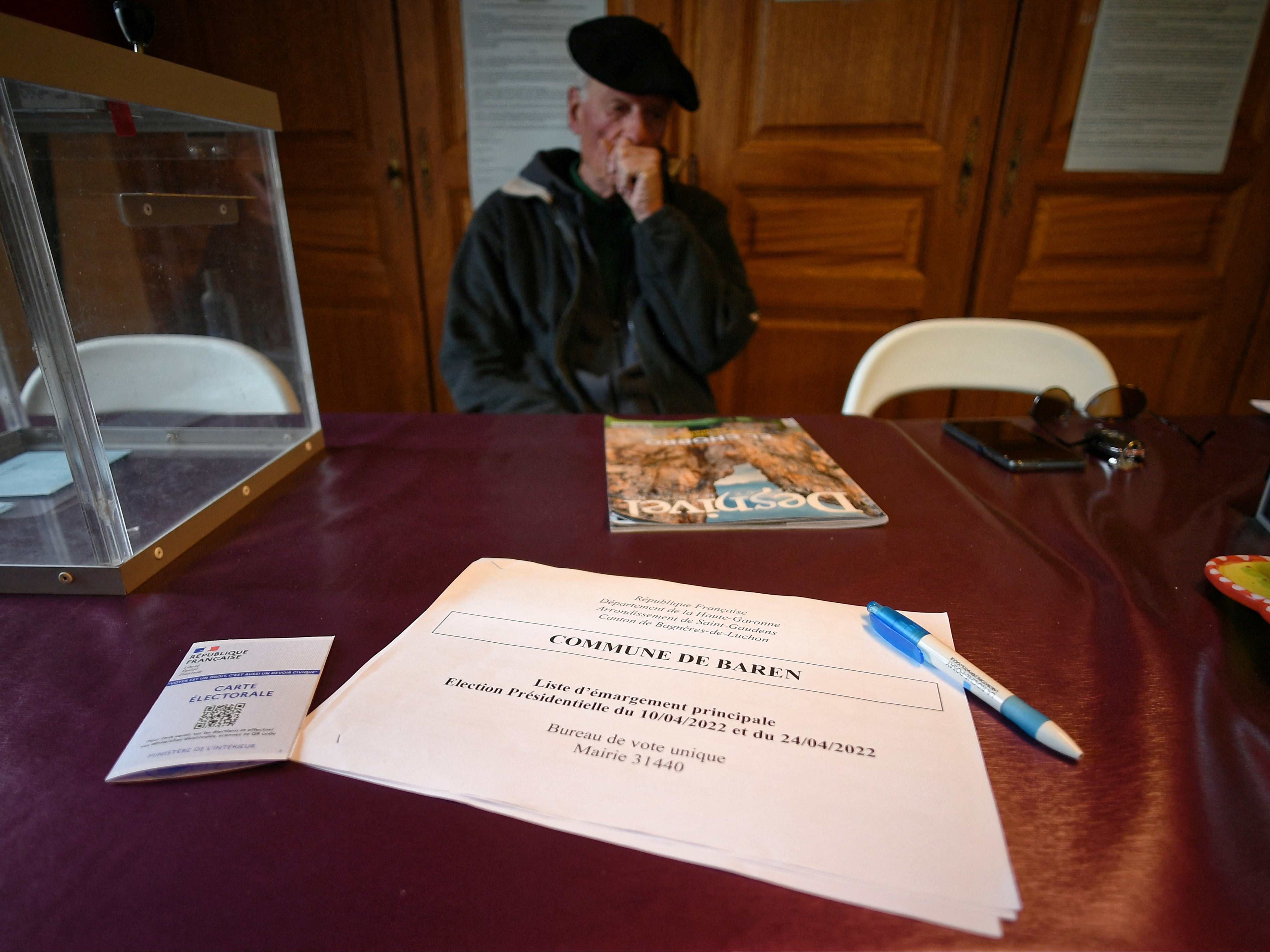 Andre Larrieu, the first deputy mayor, waits for voters in the village's only polling station on the day of the second round of the presidential elections in Baren, southern France