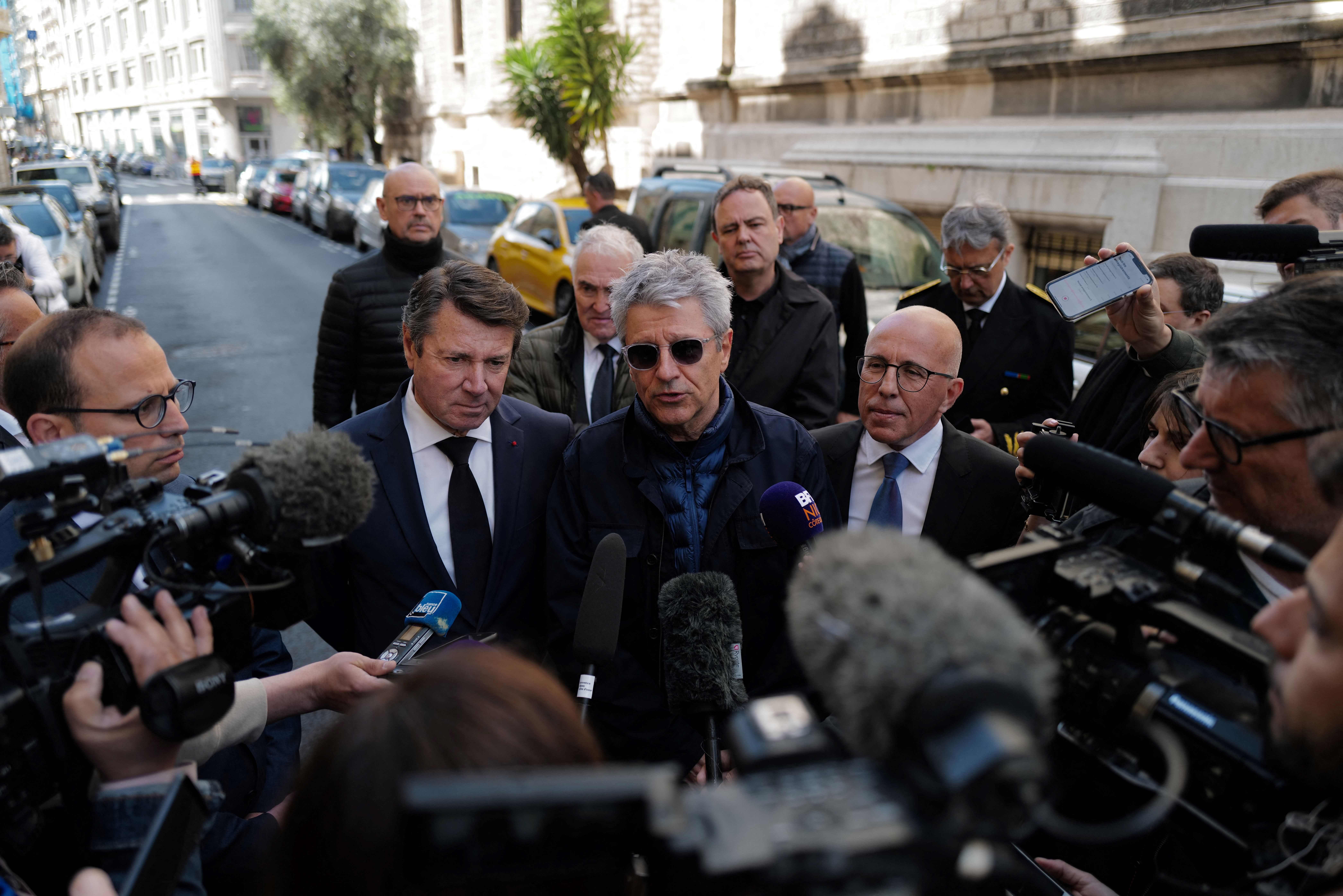 Nice's mayor Christian Estrosi, local prefect Bernard Gonzalez (C) and local MP Eric Ciotti give a press conference outside Saint-Pierre d'Arene church following the attack of a priest