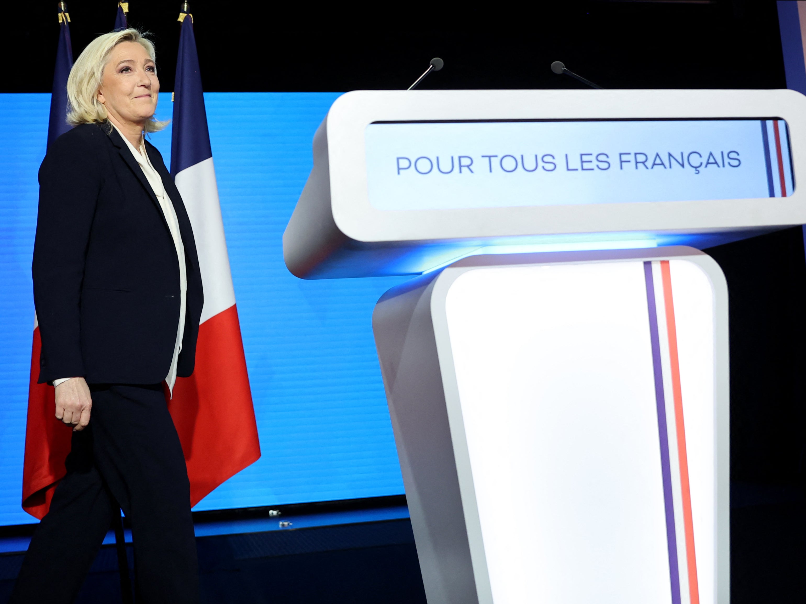 Marine Le Pen arrives on stage for a speech after the announcement of the first projections by polling firms of the French presidential election's second round results