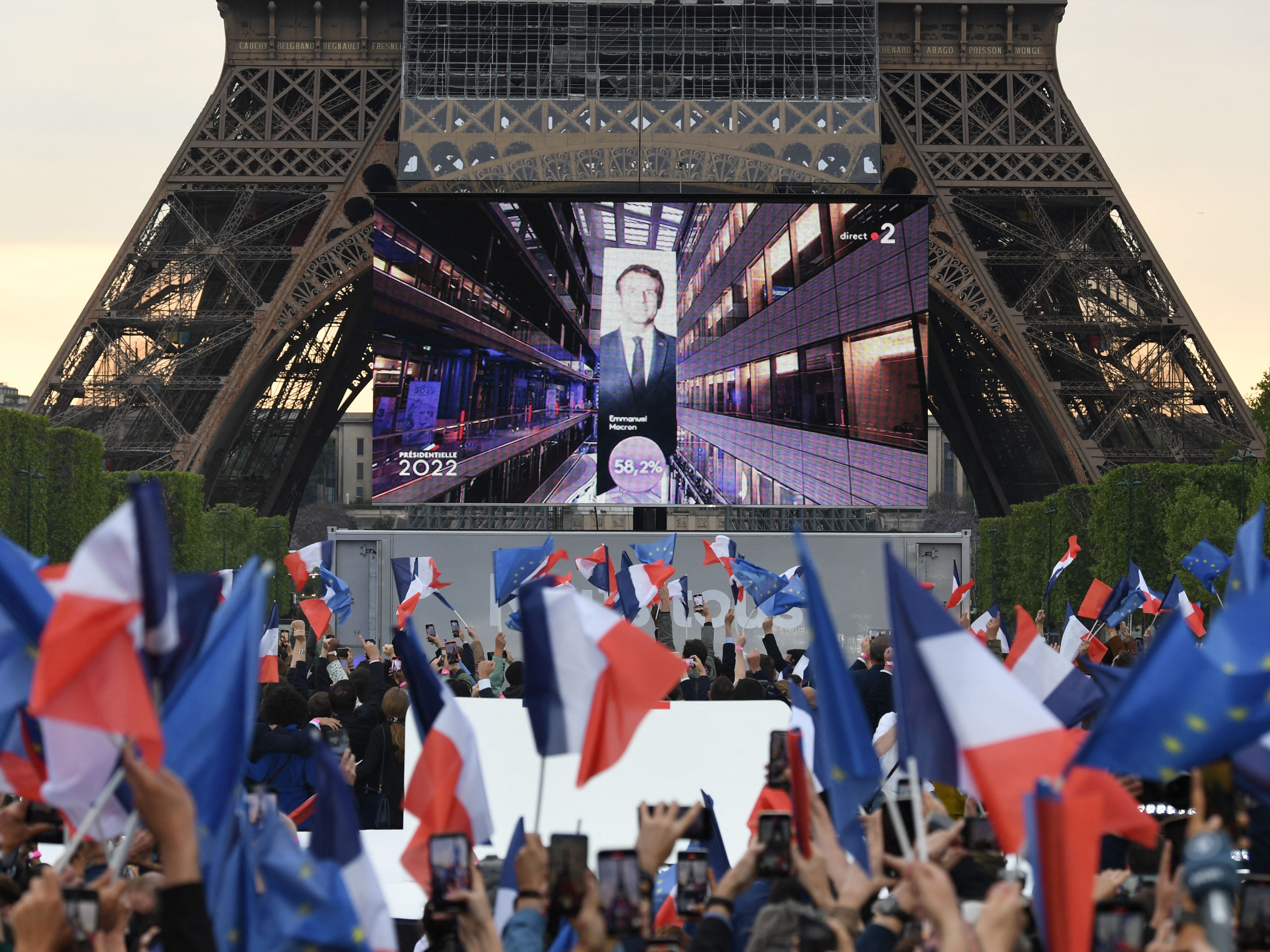 Supporters react after exit polls predict Macron win