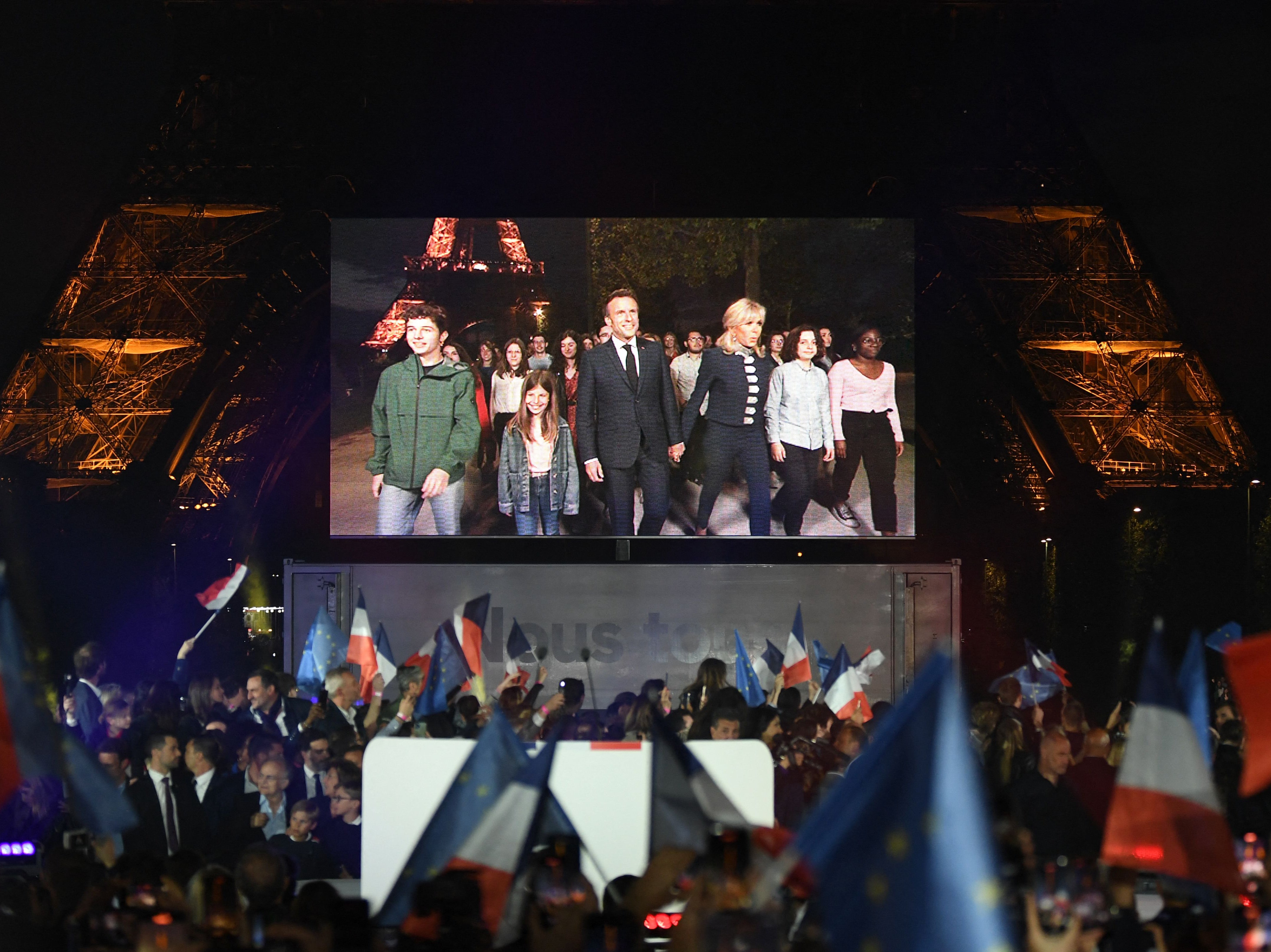 Emmanuel Macron and his wife Brigitte Macron arrive after his victory in France’s presidential election at a rally in Paris