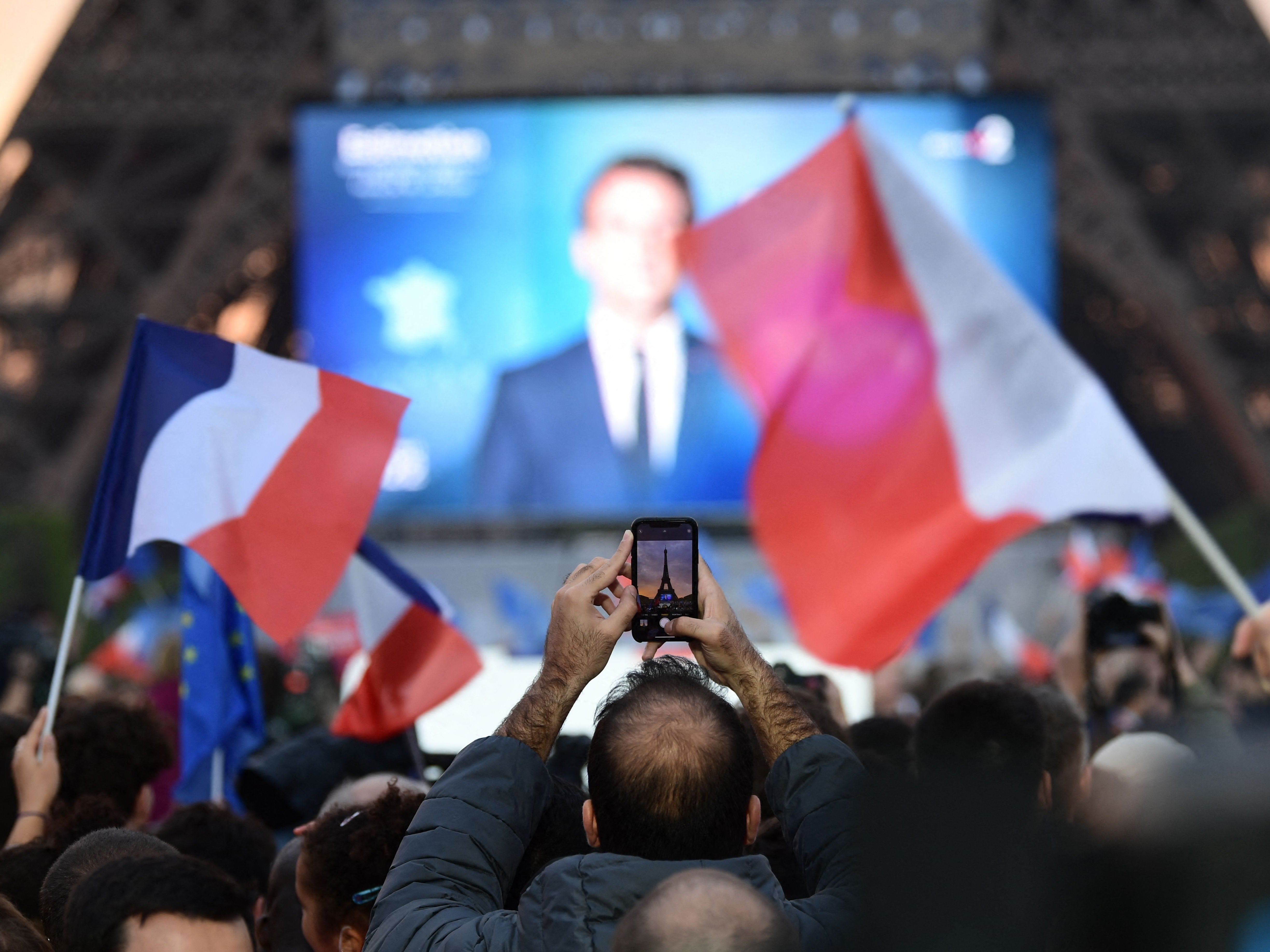 Supporters react after the victory of French President and La Republique en Marche party candidate for re-election Emmanuel Macron in France’s presidential election, at the Champ de Mars, in Paris