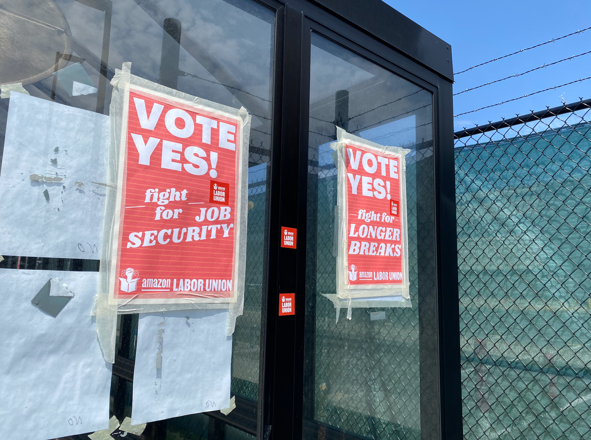 Posters outside a bus stop at Amazon facilities in Staten Island encourage workers to support union efforts.