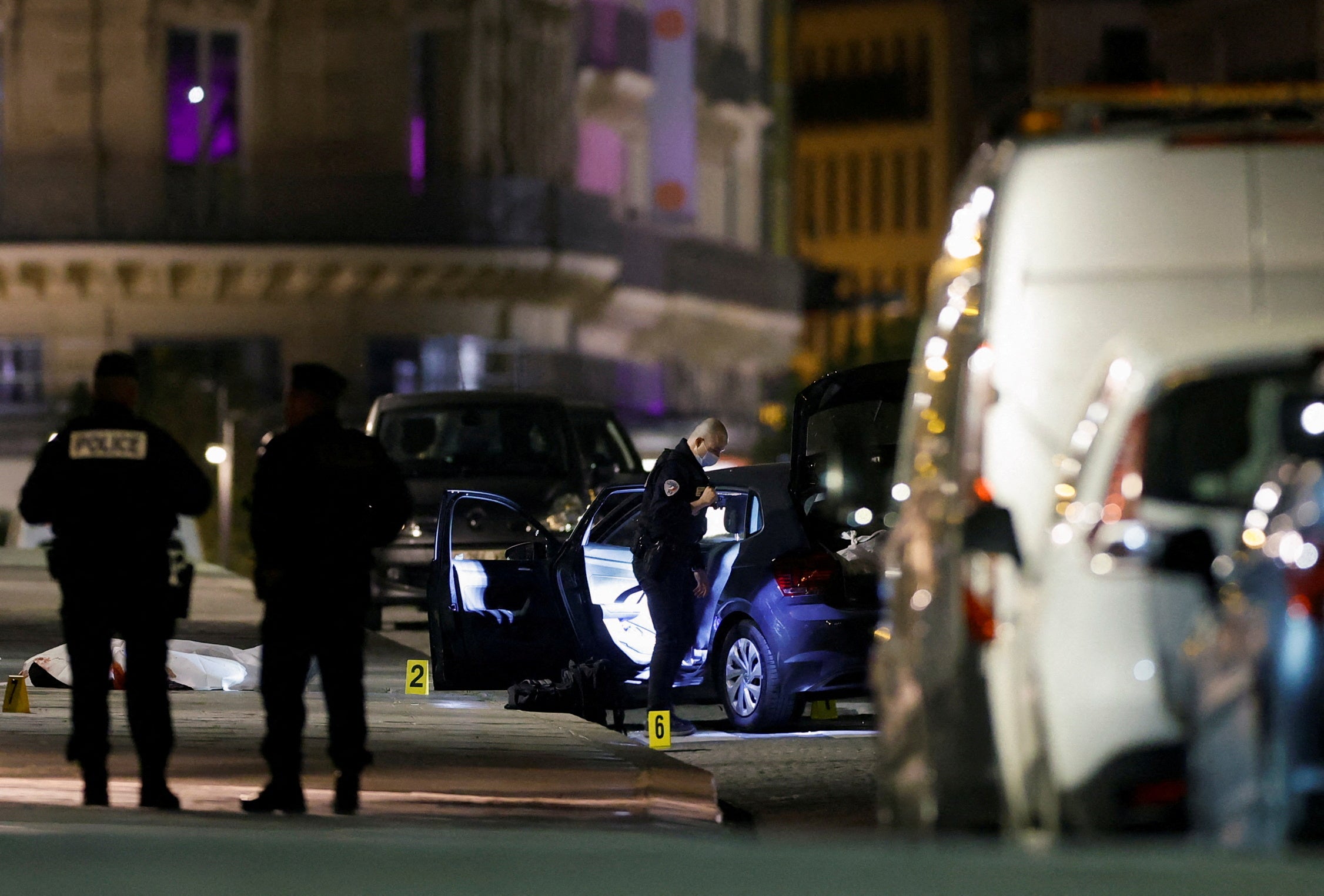 French police forensic officers inspect the scene of a shooting on the Pont Neuf bridge in Paris, France