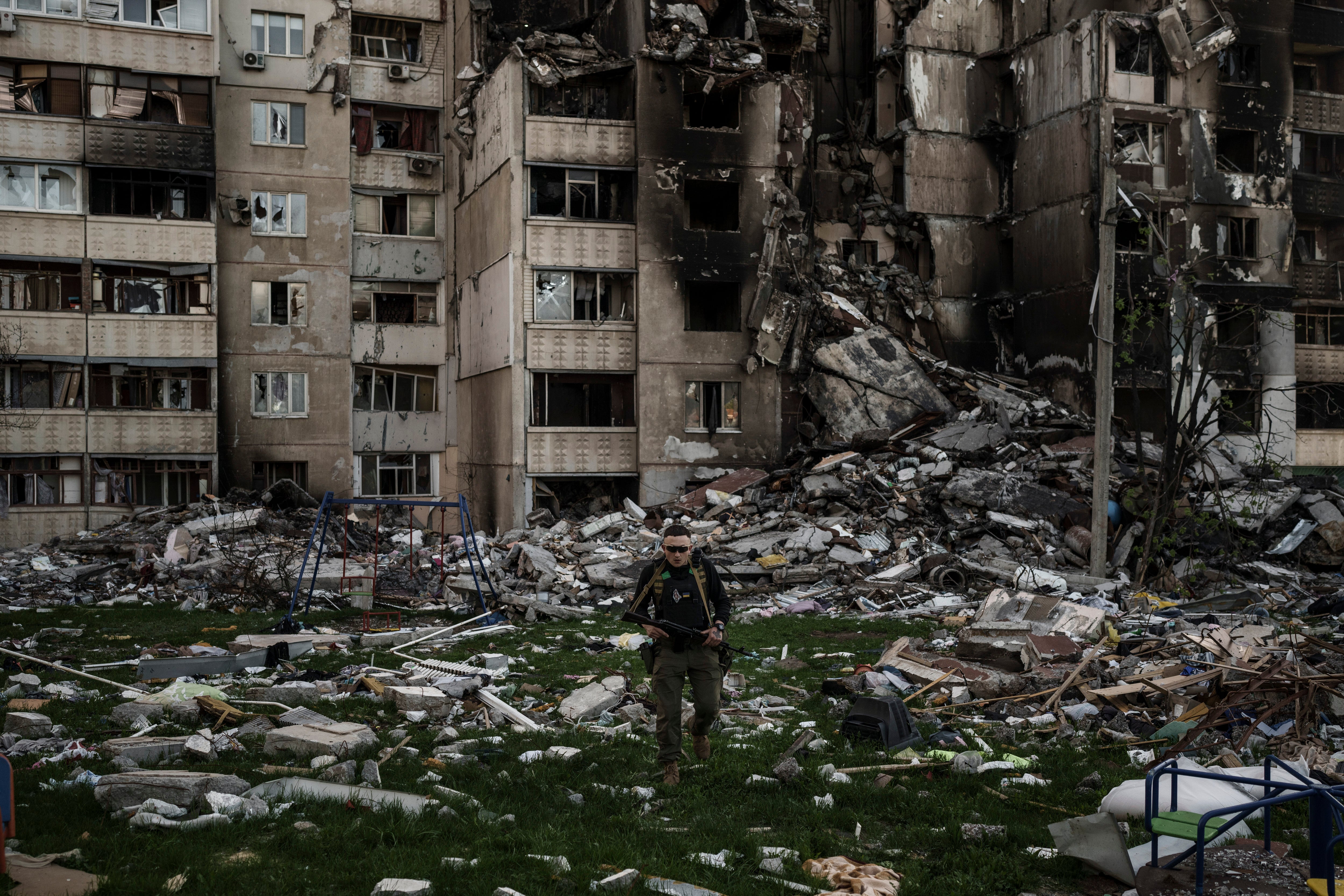 A Ukrainian serviceman walks amid the rubble of a building heavily damaged by multiple Russian bombardments near a frontline in Kharkiv, Ukraine (Felipe Dana/AP)