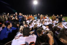 ‘If he wins, they’ll implement a Christian version of sharia law’: The community divided by prayers of high school football coach