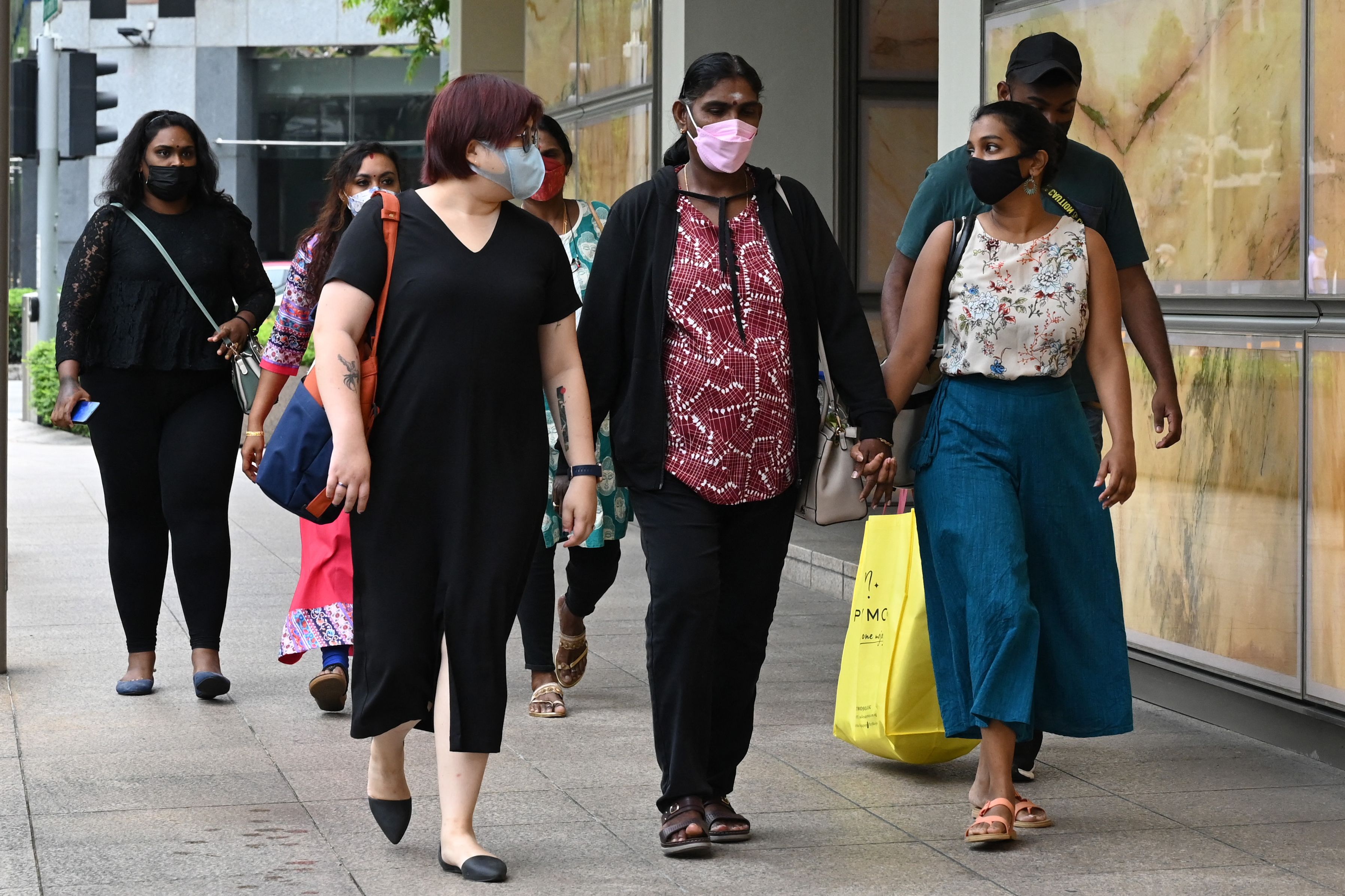 Panchalai Supermaniam (centre), mother of the Malaysian national Nagaenthran Dharmalingam sentenced to death for trafficking heroin into Singapore, arrives at the Supreme Court for the final appeal in Singapore on 26 April 2022