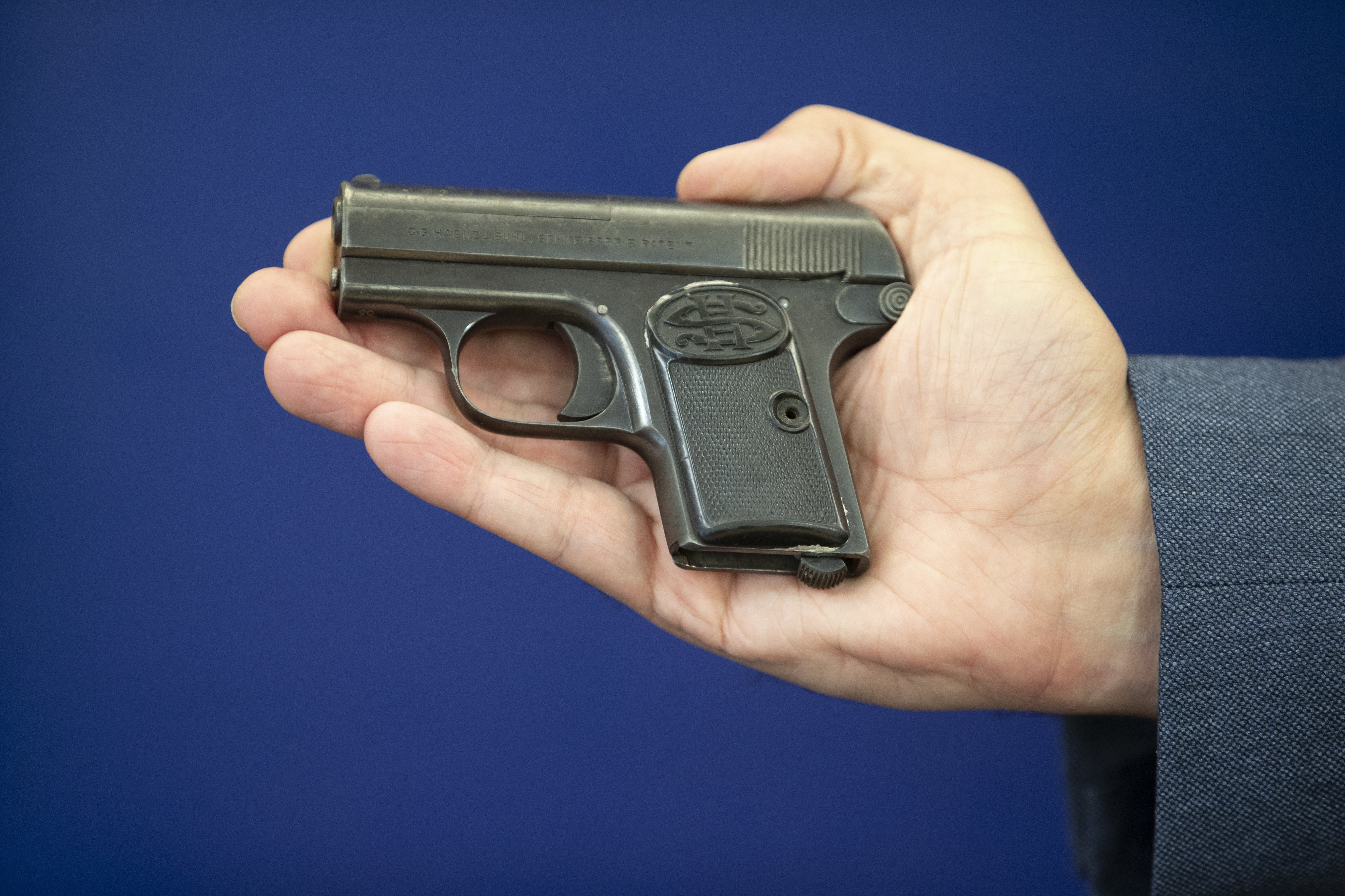 Detective Inspector Gary Winter holds a replica of the gun, used in the killing of Alistair Wilson, during a press conference to appeal for new information at Inverness Police Headquarters