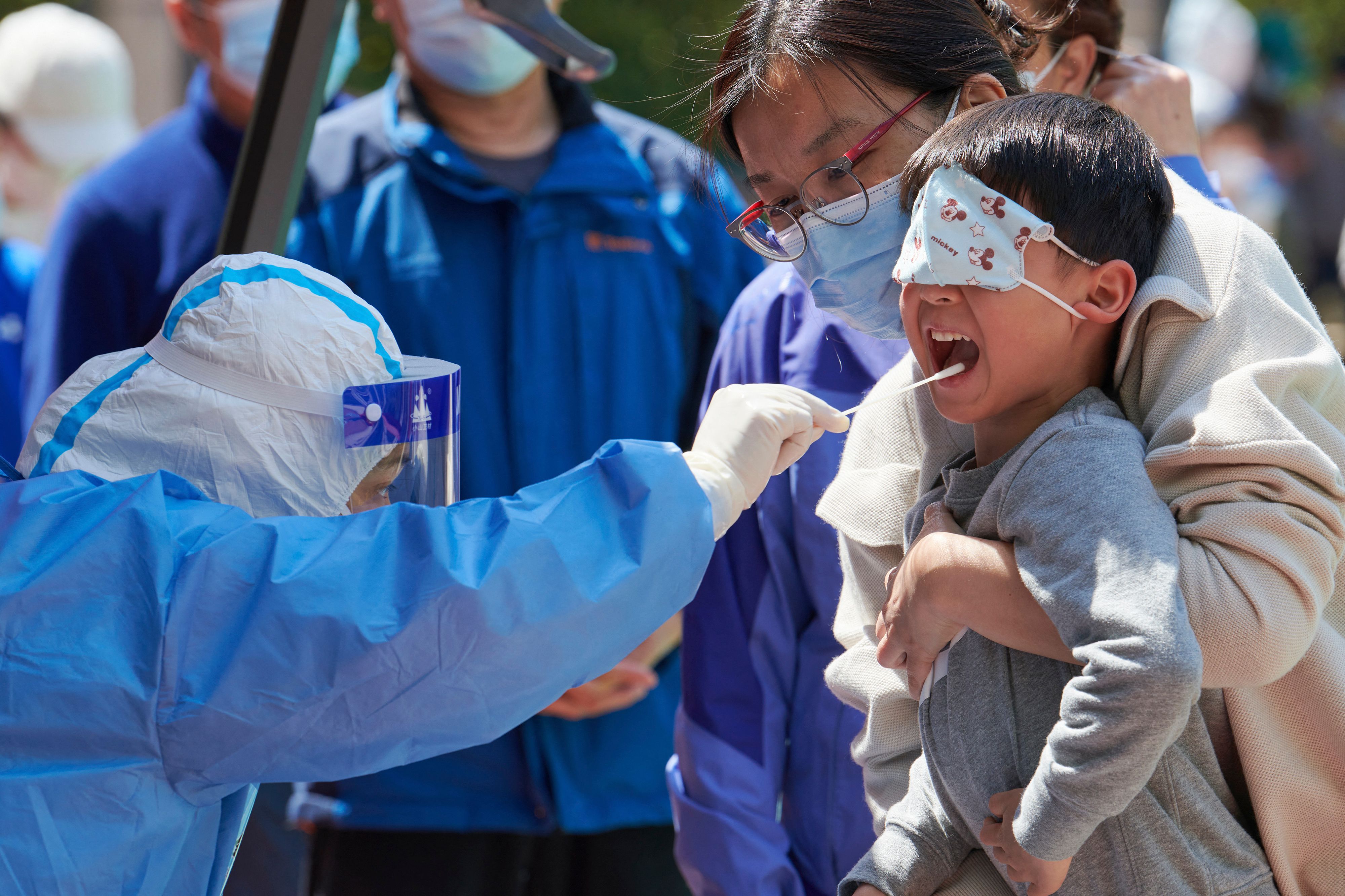 A child receives a swab test for Covid in Pudong district in Shanghai on April 17, 2022