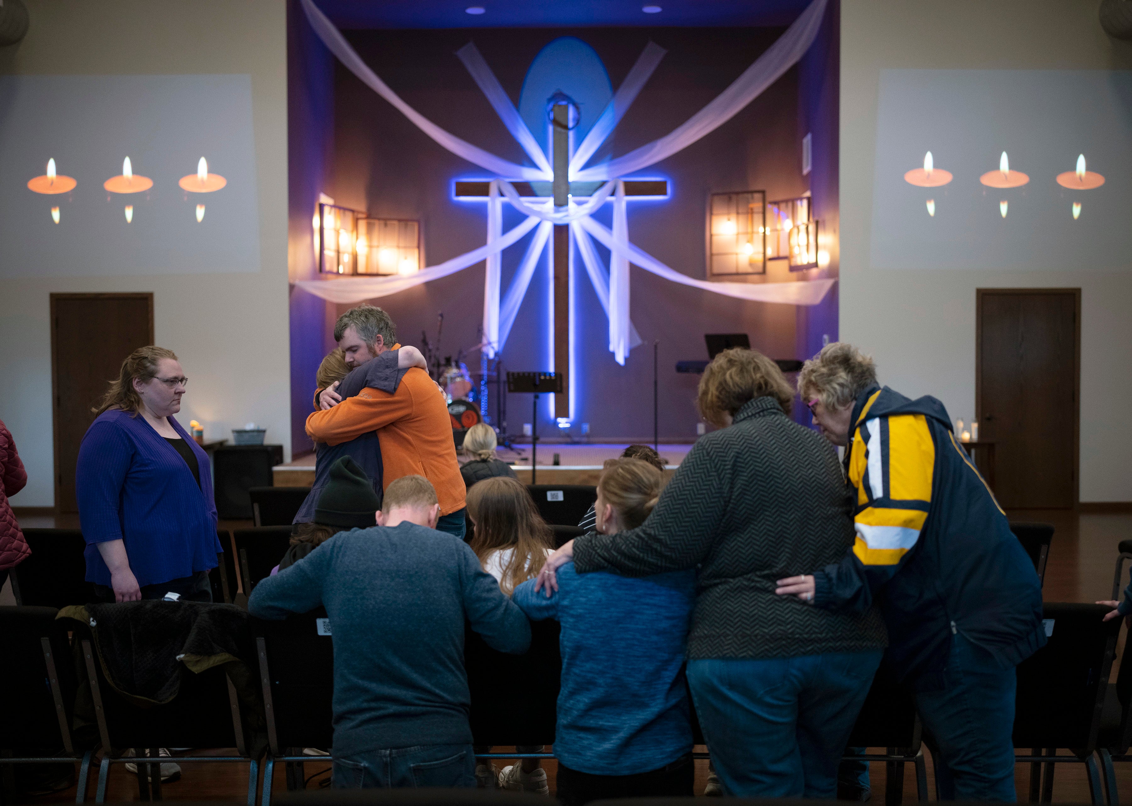 Relatives of Iliana “Lily” Peters comfort each other as they pray together at a vigil for the 10 year-old girl at Valley Vineyard Church in Chippewa Falls