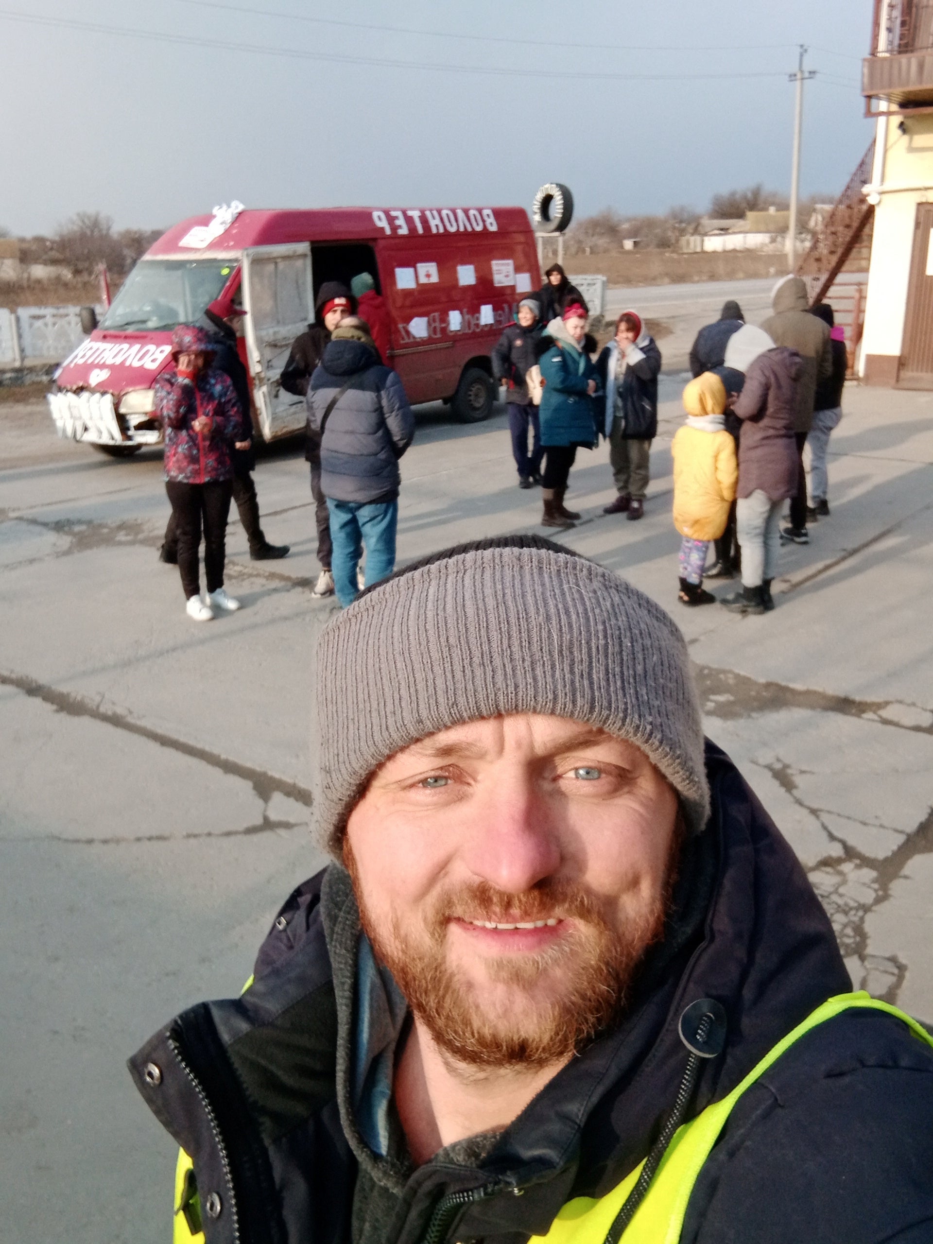 Mykhailo Puryshev poses for a selfie photo in front of a car as he evacuates people fleeing Russia’s invasion of Ukraine, in Zaporizhzhia