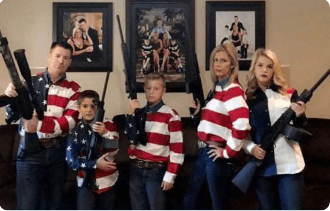 Oklahoma GOP chairman John Bennett and family pose with automatic weapons