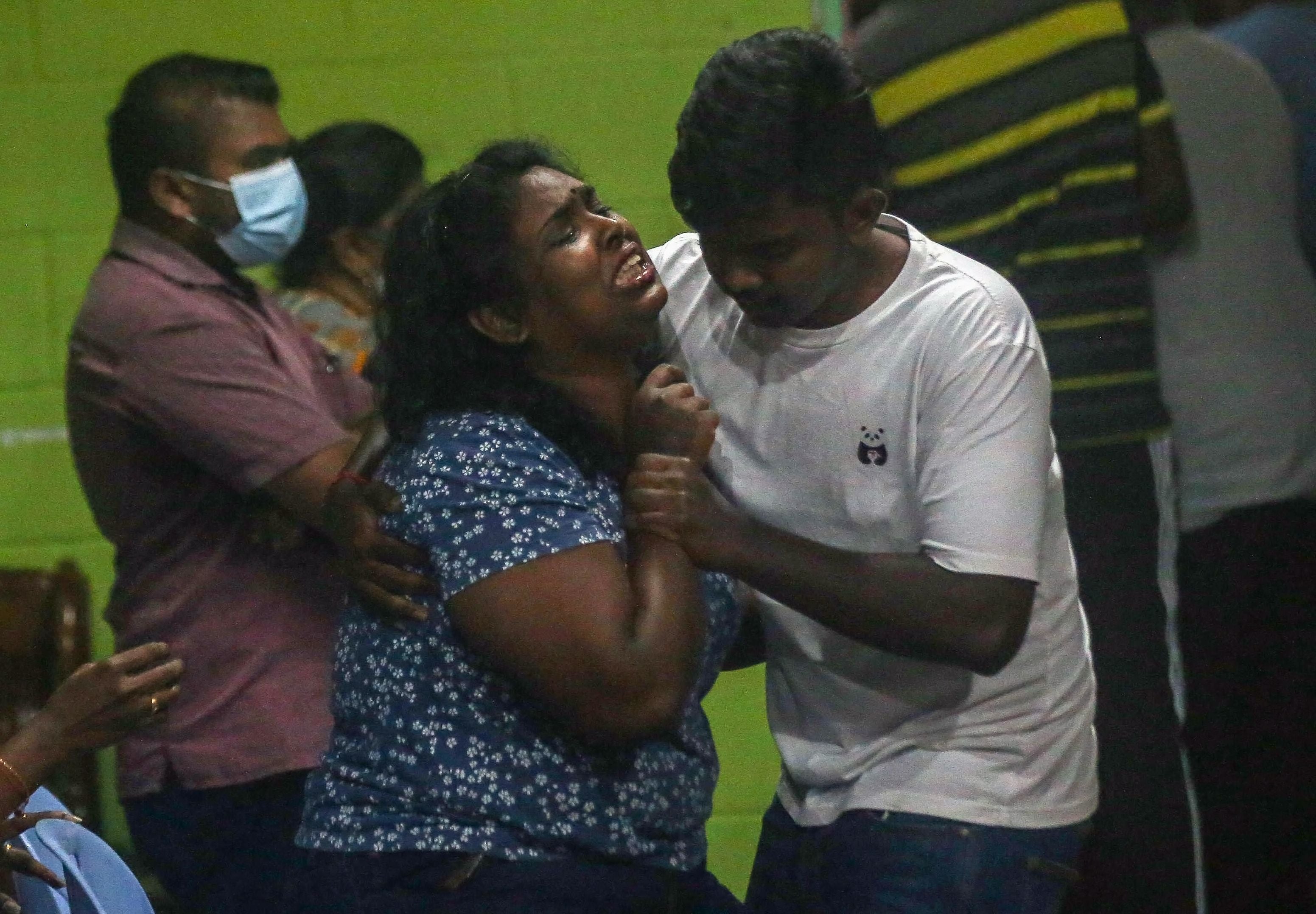 A family member reacts as the coffin carrying the body of Malaysian national Nagaenthran Dharmalingam arrives in Tanjung Rambutan in Malaysia's Perak