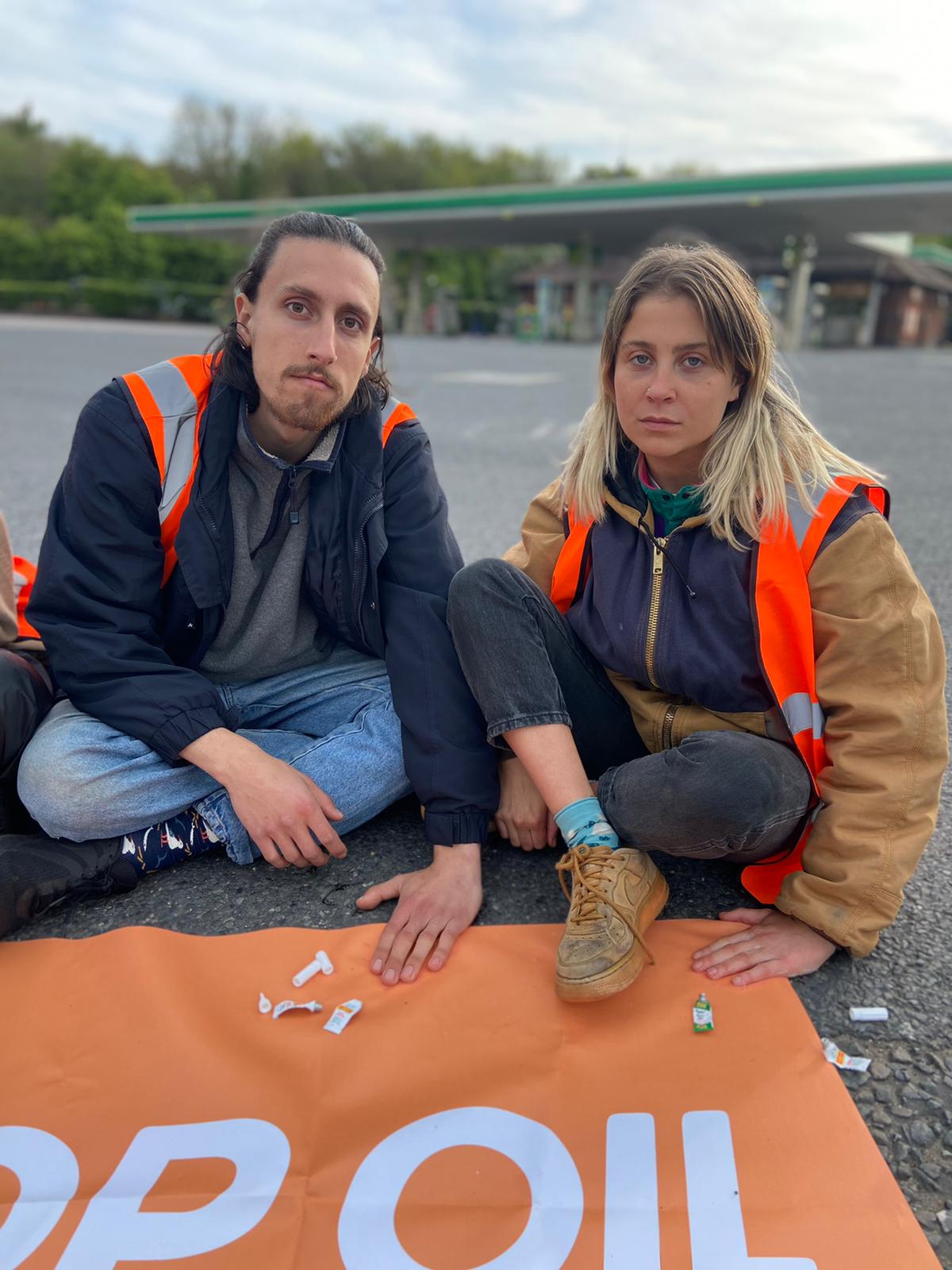 Eben Lazarus, 22, and Hannah Hunt, 23 block the entrance to the petrol forecourt on the M25.