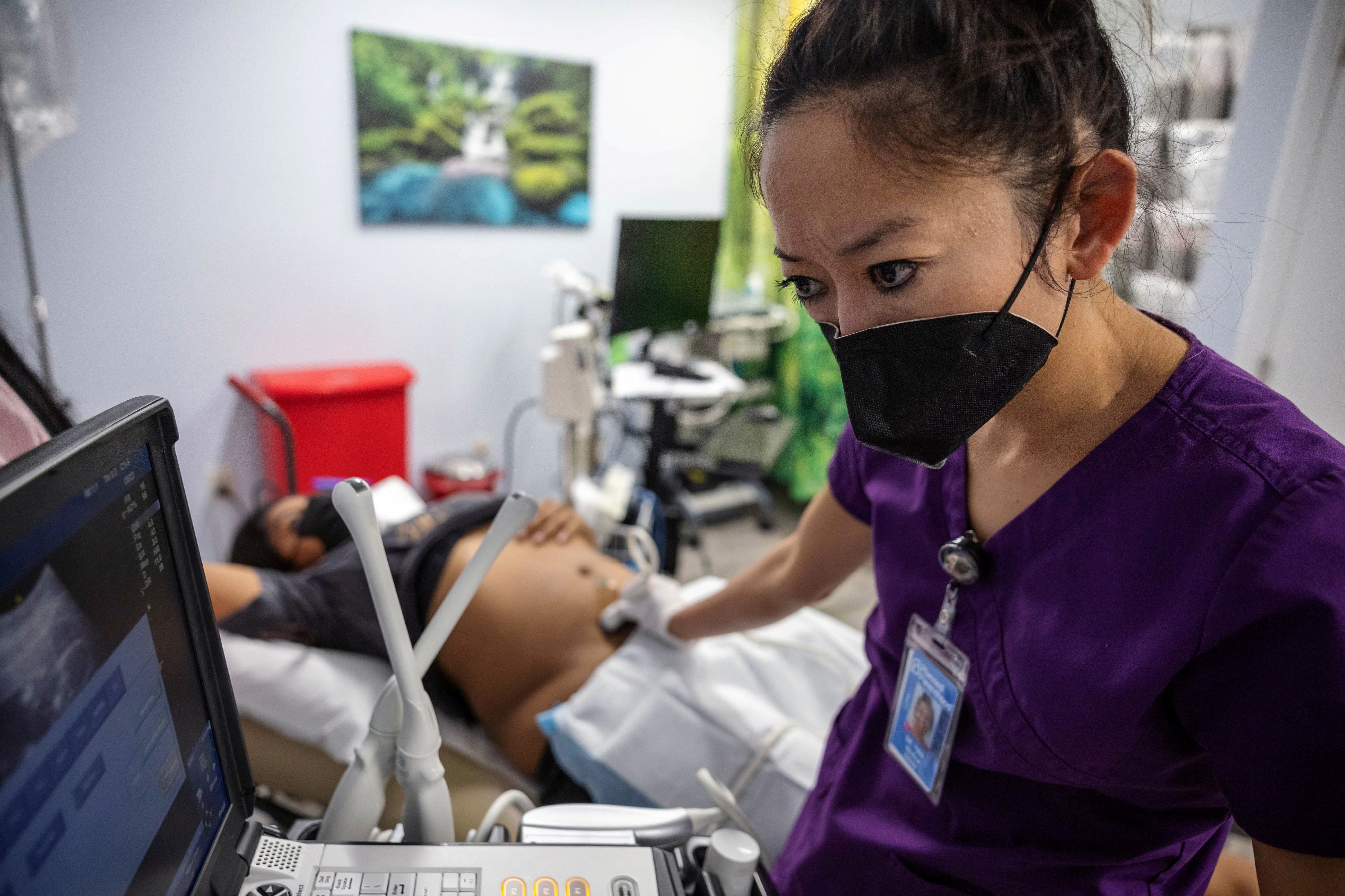 Dr Tien performs an ultrasound on MC, who is in her second trimester, at Planned Parenthood in Jacksonville