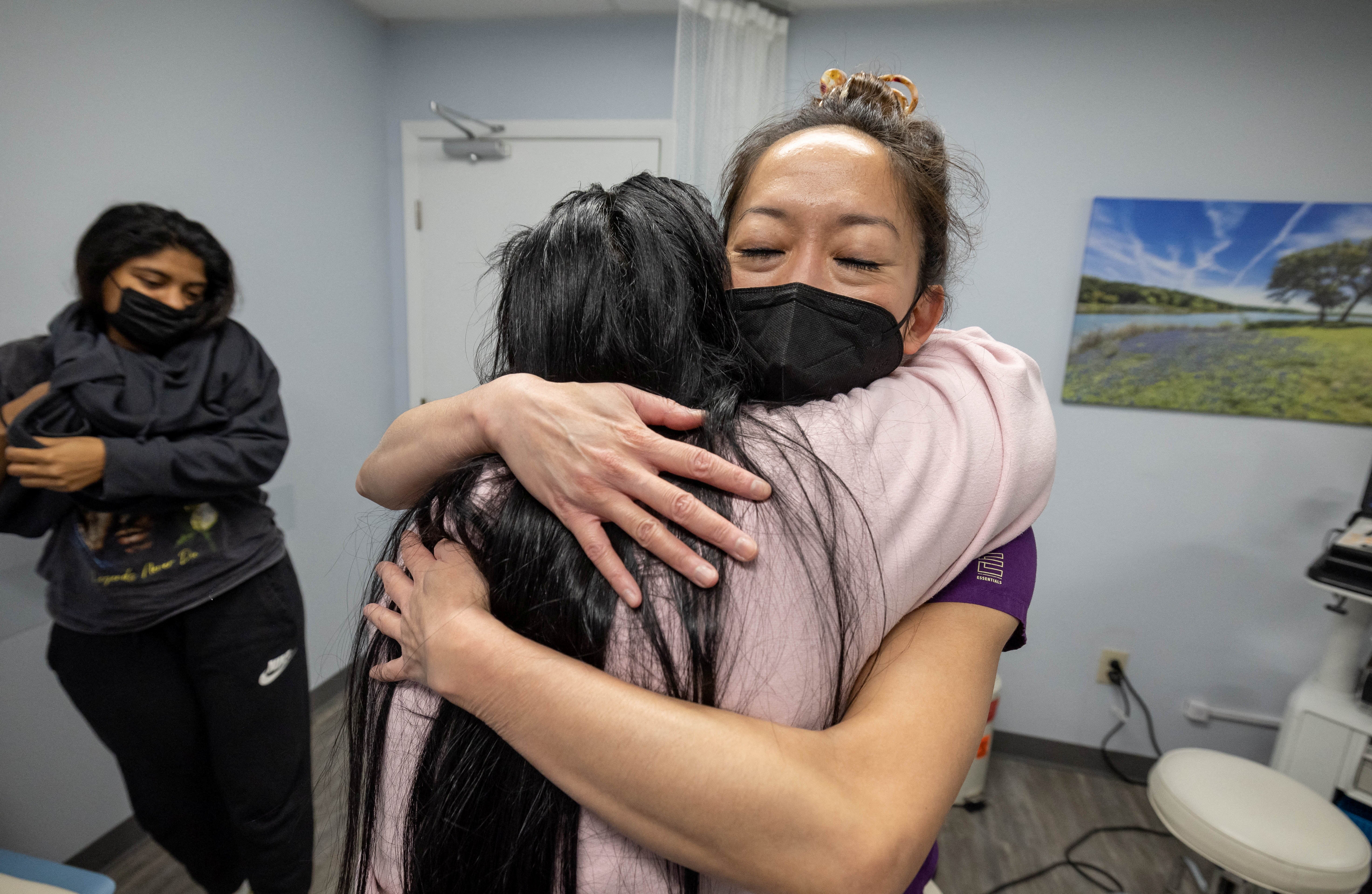 OC, the older sister of MC, hugs Tien in gratitude, following her sister’s appointment