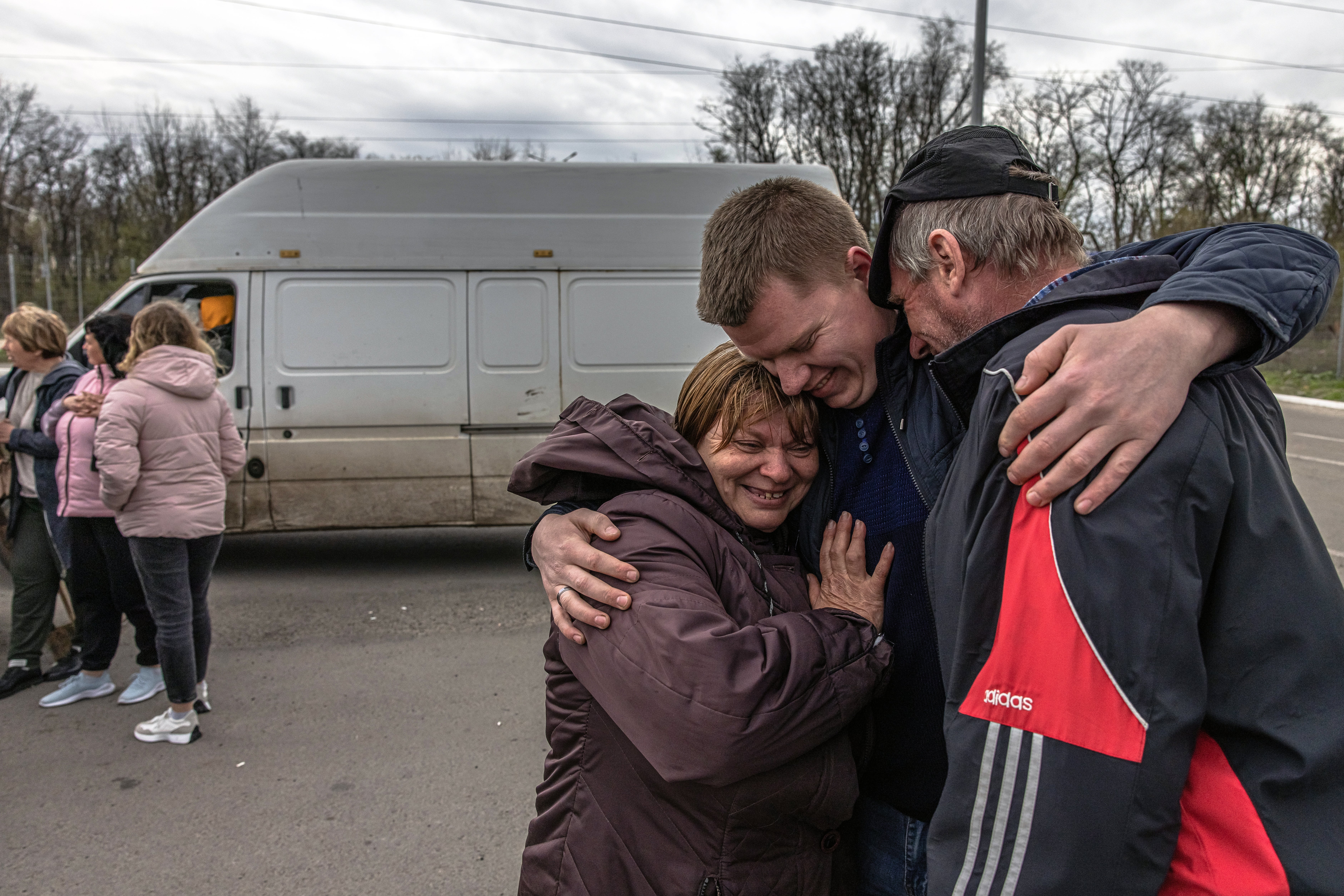 Oleksandr (25, C), meets his parents Olga (49) and Oleksandr (50) who fled from the currently Russian-occupied village Lyubimivka, at the evacuation point in Zaporizhzhia, Ukraine, 23 April 2022