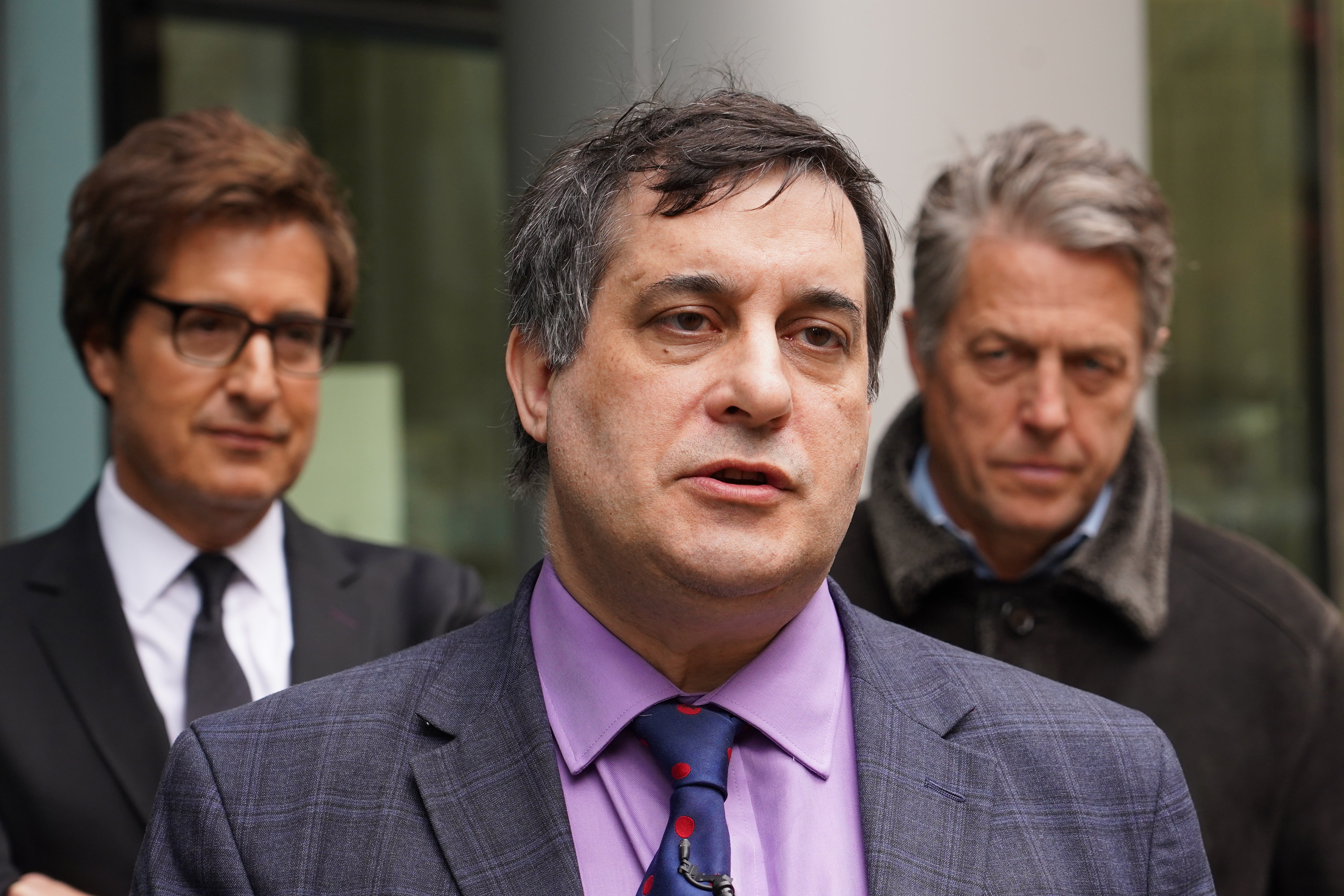 Actor Hugh Grant (right) with David Sherborne (left) outside the Rolls Building in central London, where they were supporting campaigner Dr Evan Harris (centre)