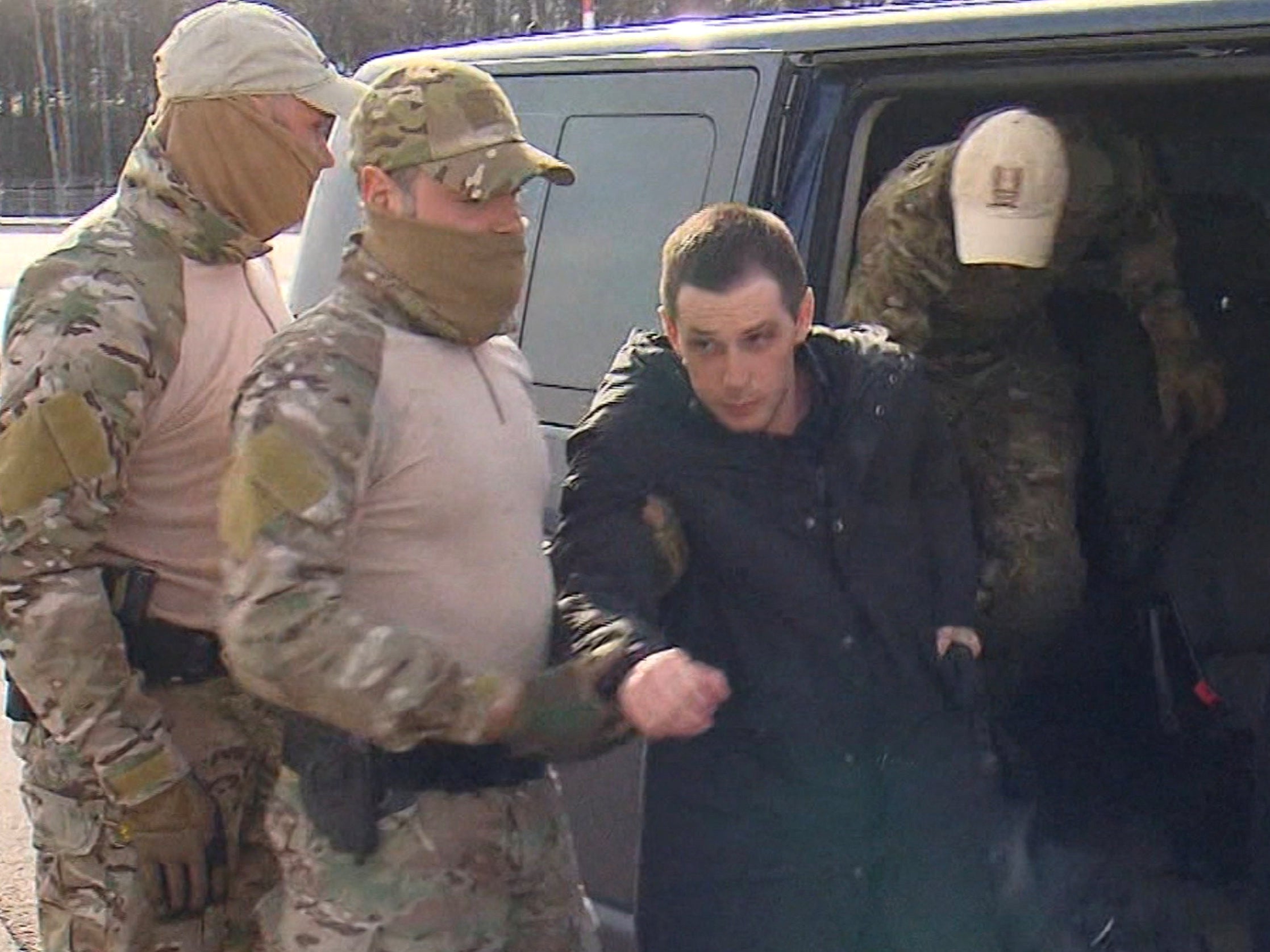 Trevor Reed, 30, being escorted by Russian service members