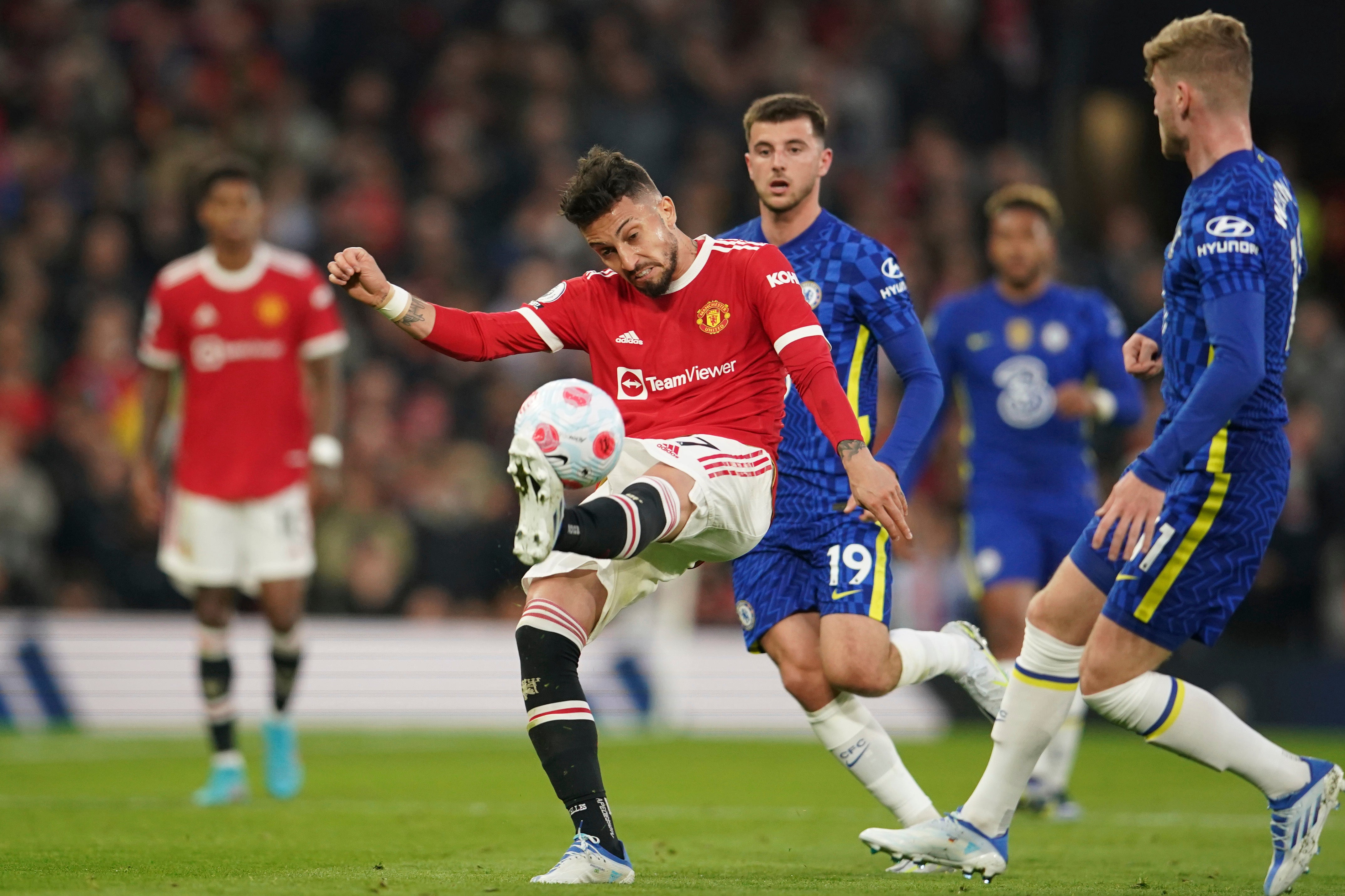 Alex Telles kicks the ball