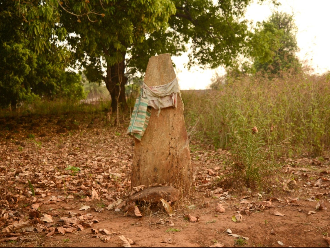 The tombstone in Badru Madvi’s name outside his village in Gampur