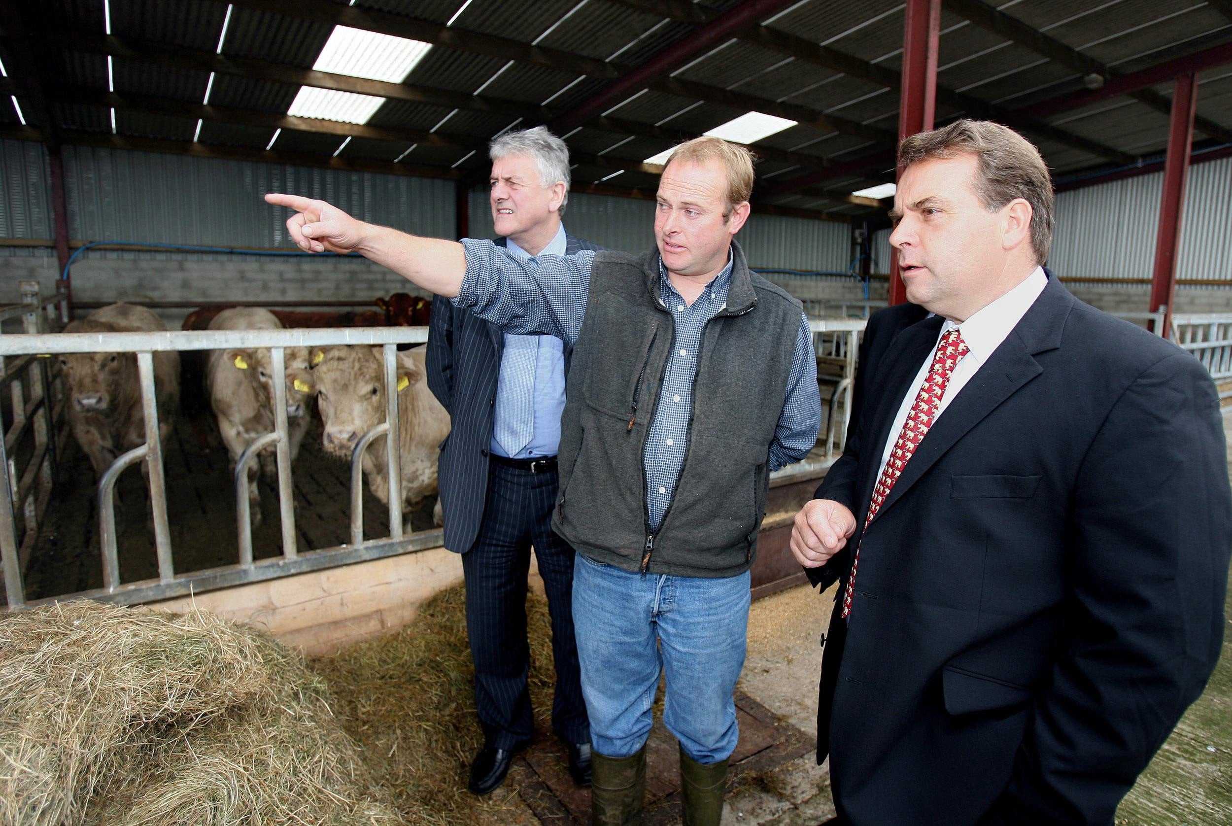 Farmer Ivan McMullan shows then MEP Neil Parish (right) and MEP Jim Nicholson (left) his farm in Carnlough Co Antrim (PA)