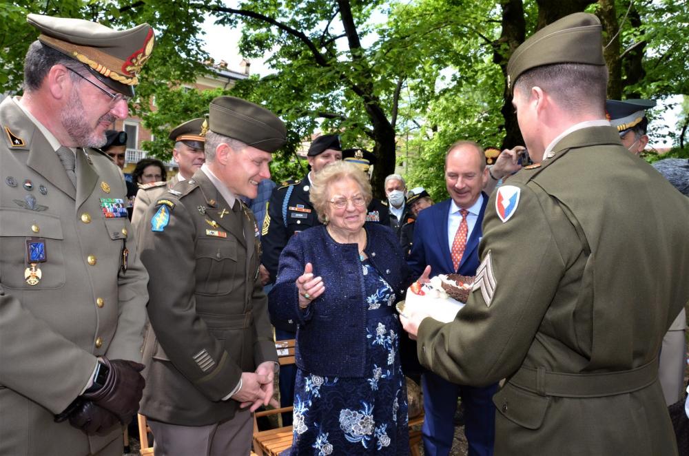 Meri Mion, 90, receives a birthday cake from the US military in Vicenza, Italy, to replace the one American troops stole from her in 1945