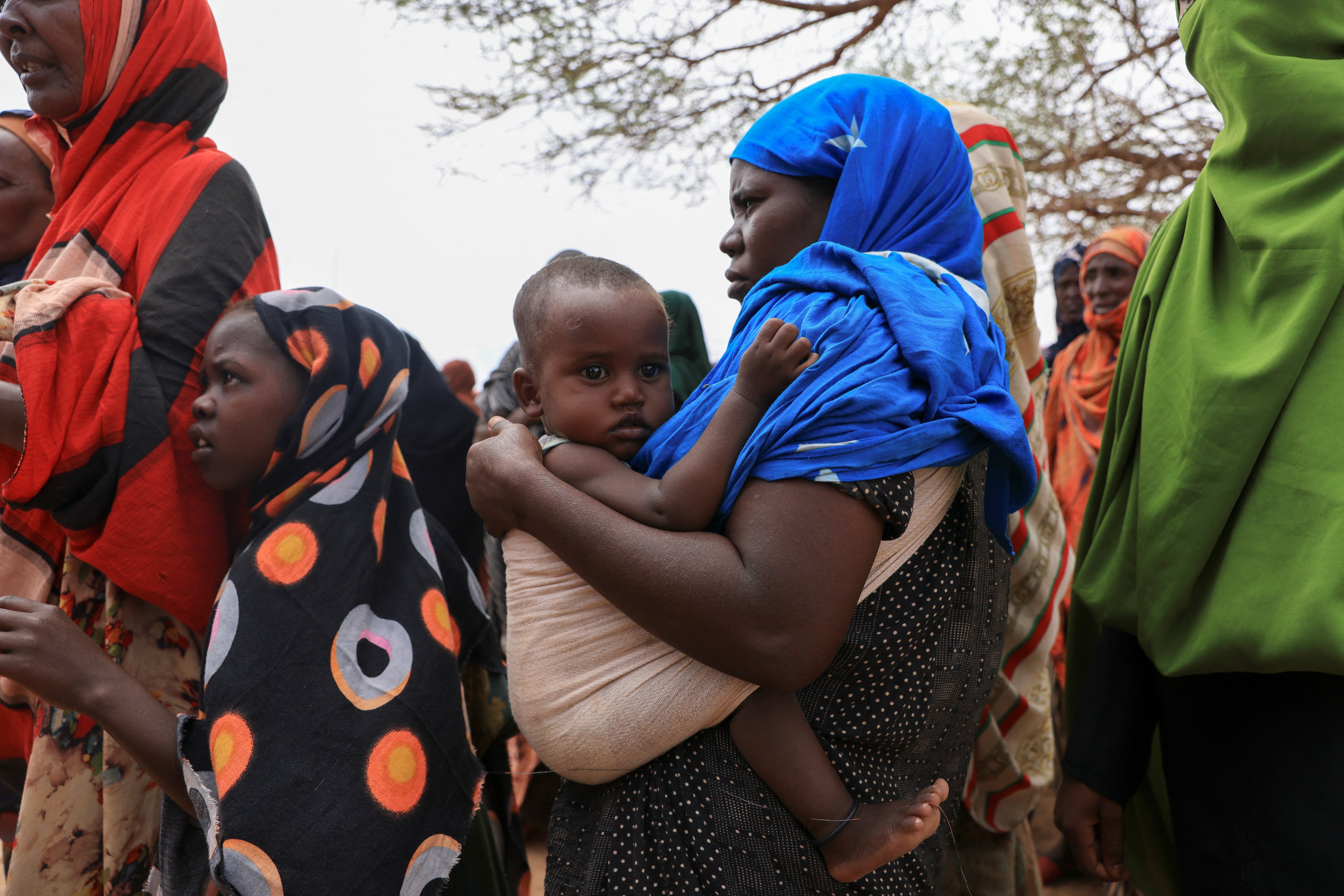 Women queue to receive food aid in the Higlo camp for people displaced by drought, in the town of Gode