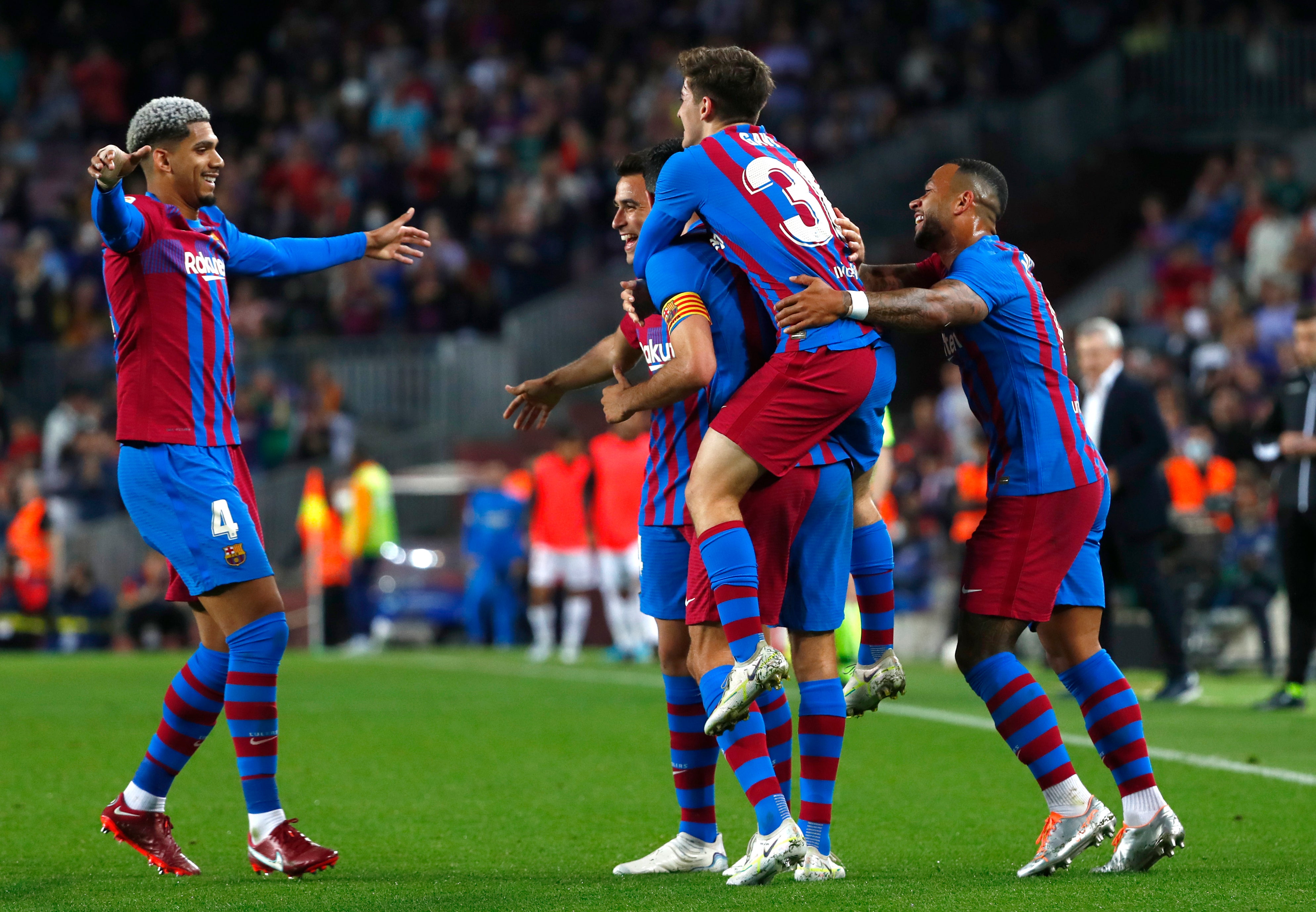 Barcelona players celebrate after Sergio Busquets scores their second goal against Mallorca (Joan Monfort/AP)