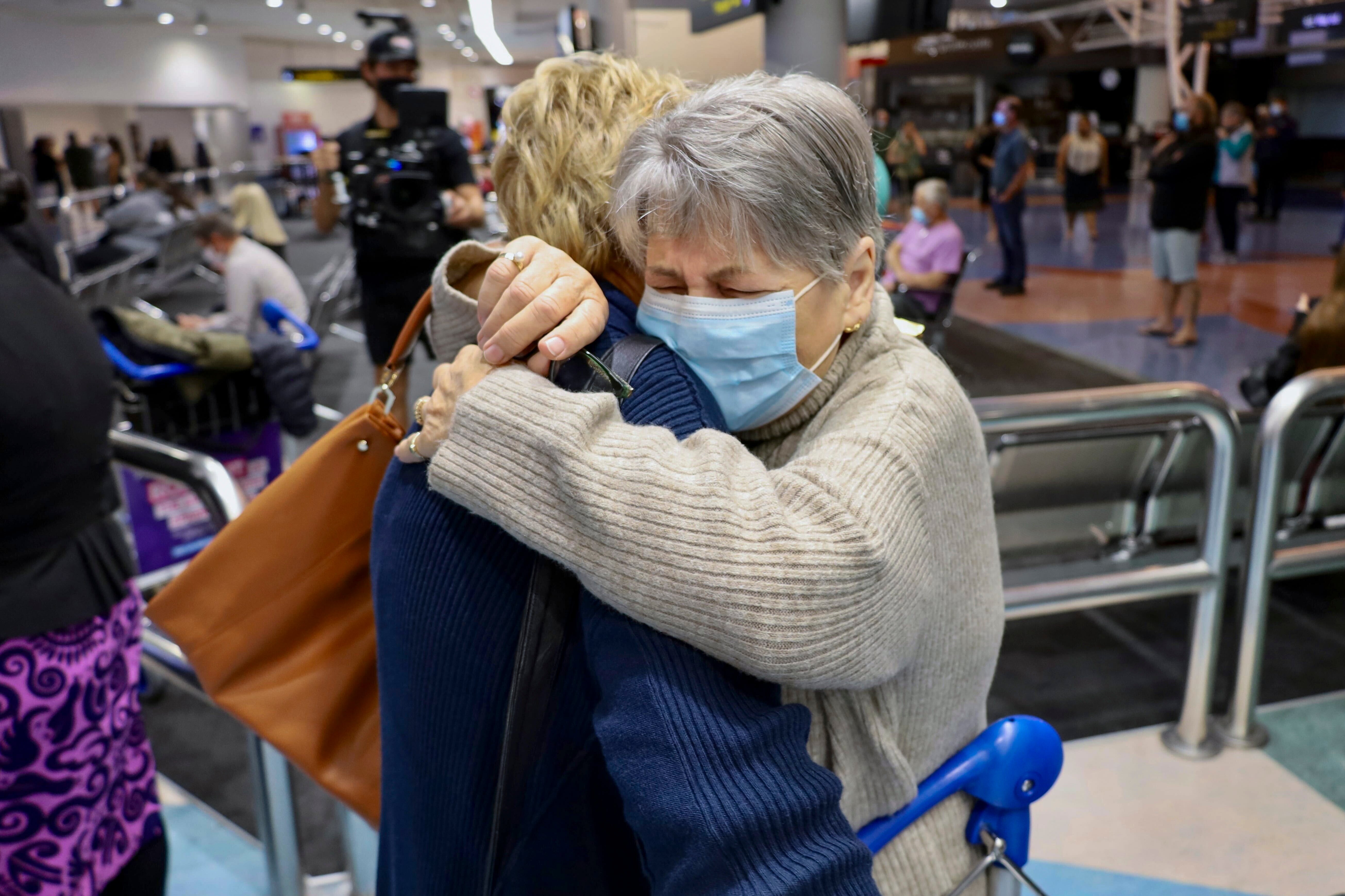 Families embrace after a flight from Los Angeles arrived at Auckland International Airport as New Zealand’s border opened for visa-waiver countries Monday, 2 May 2022