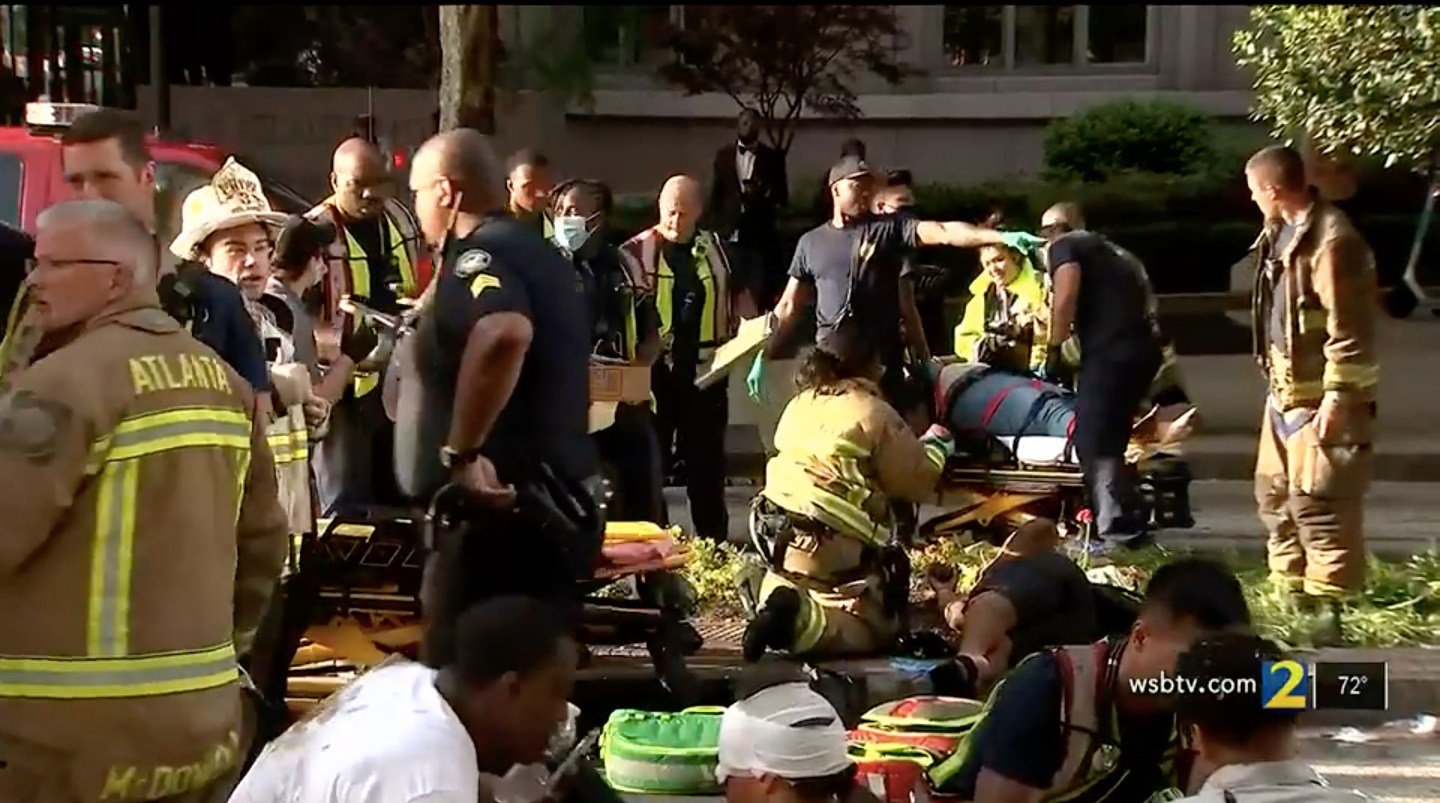 First responders from the Atlanta fire department and police department attend to victims of Saturday’s pedal pub crash.