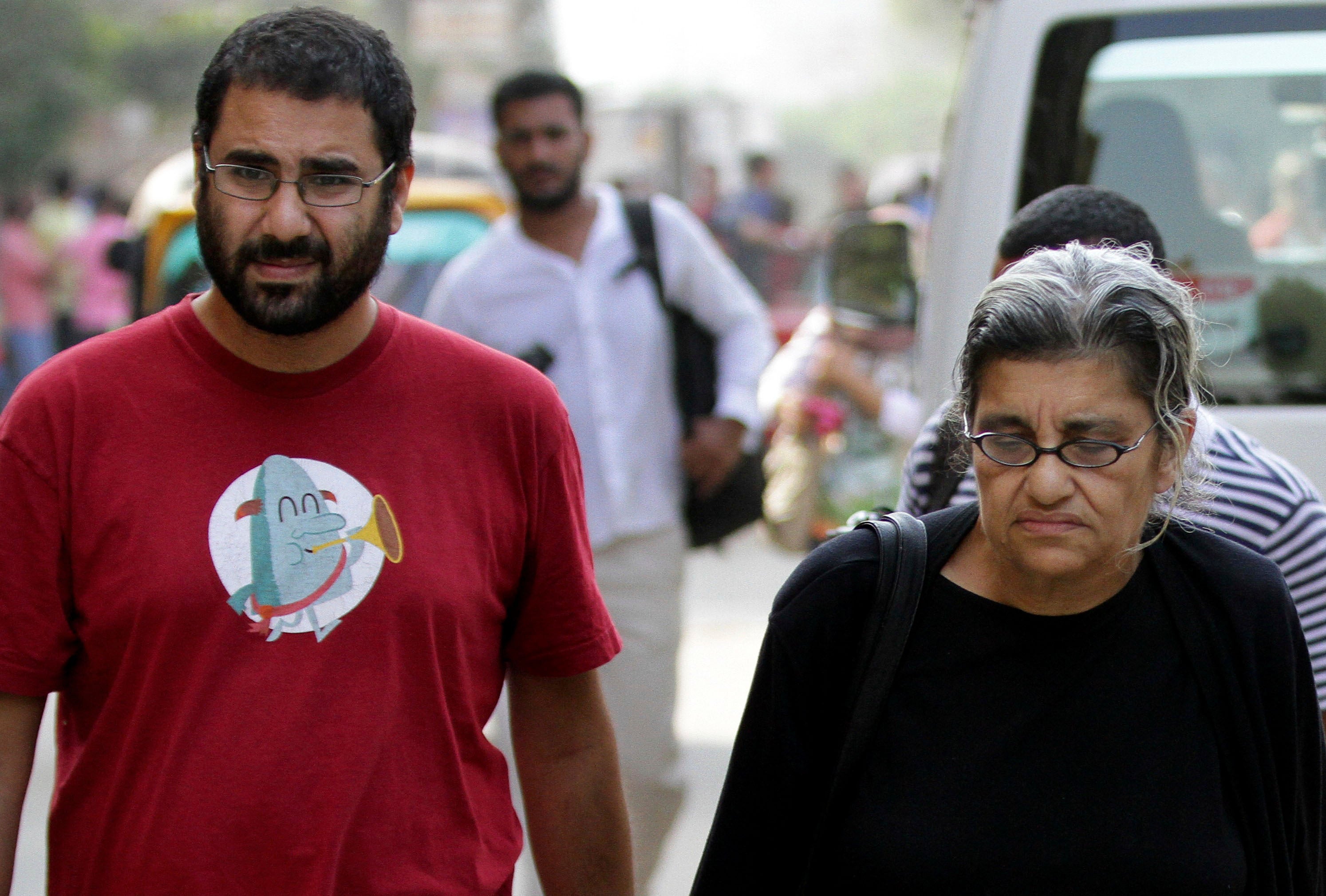 Abdel Fattah walks with his mother Laila Soueif in 2014