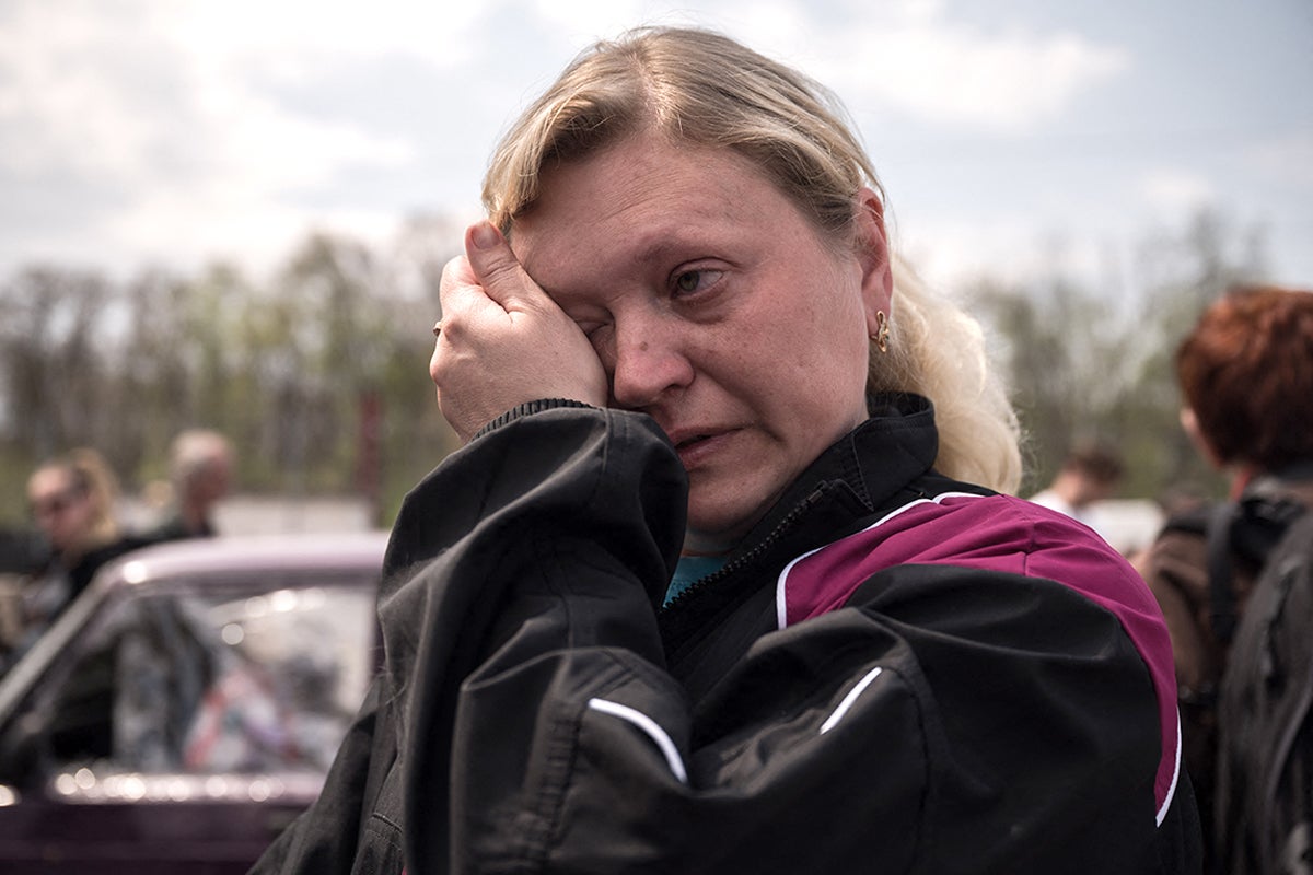 Nadiajda Vorotylina reacts after arriving with her family from the besieged city of Mariupol in their own vehicle