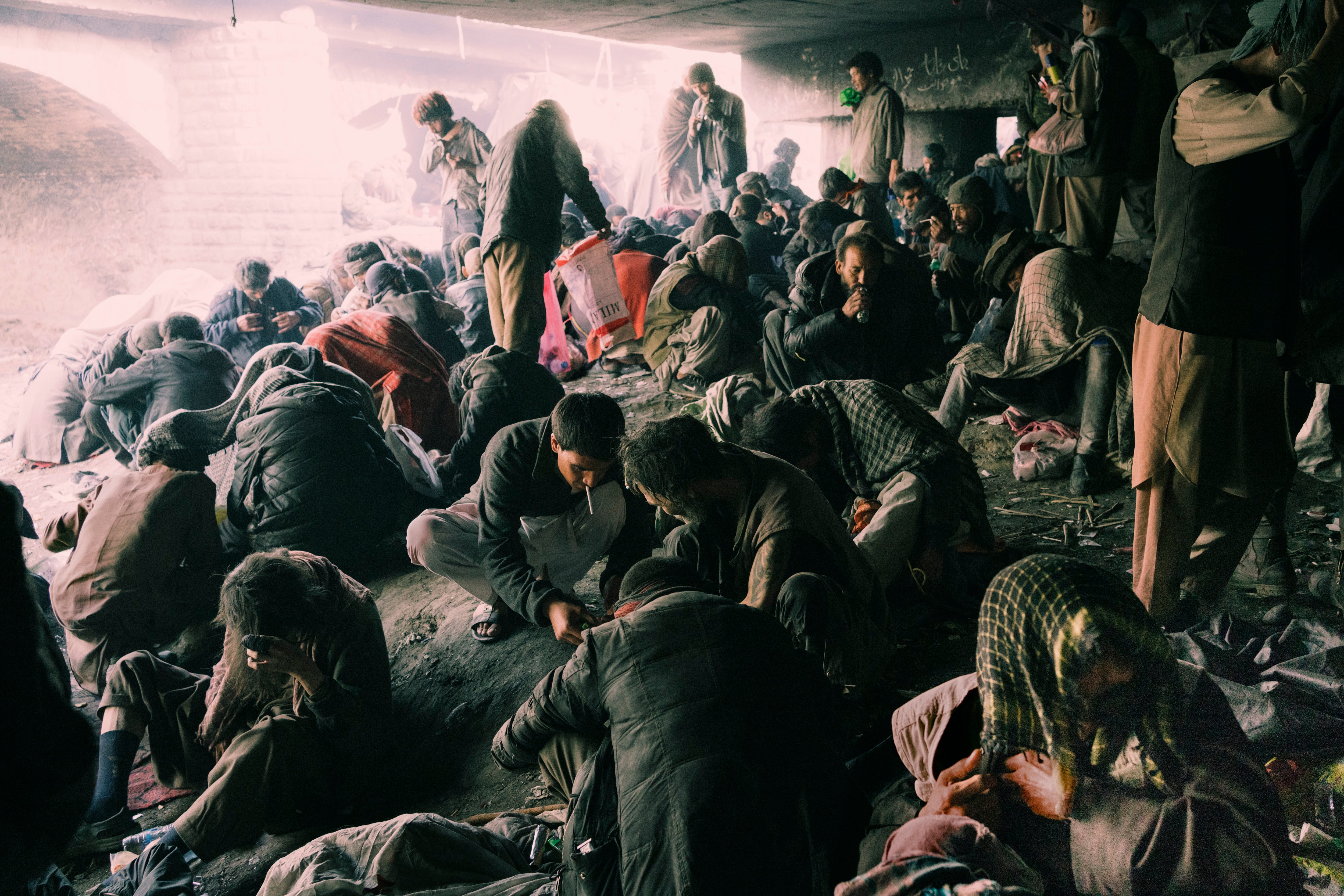 Afghans gather under a bridge in Kabul to buy and use drugs