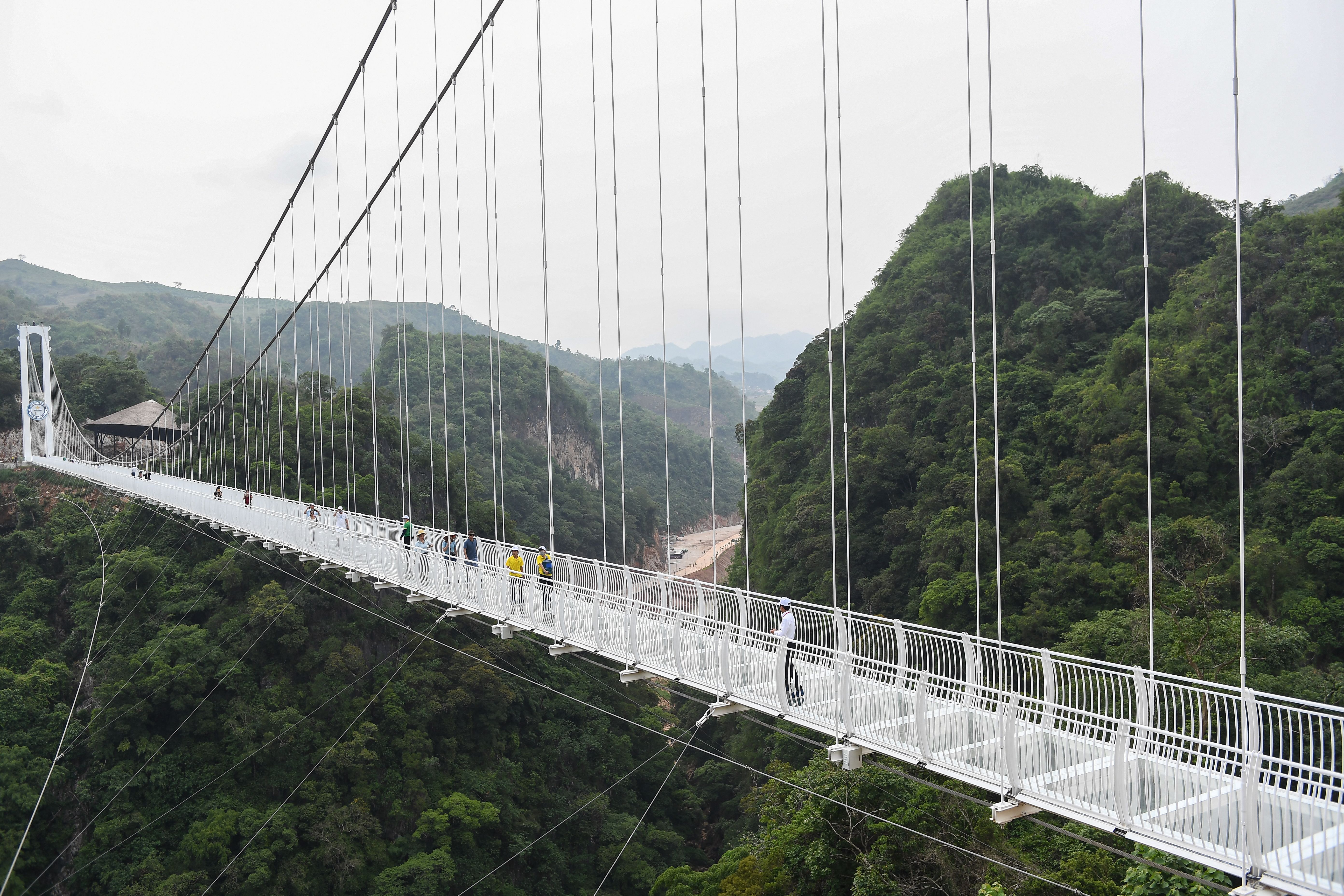 Visitors walk on the Bach Long glass bridge in Moc Chau district in Vietnam’s Son La province