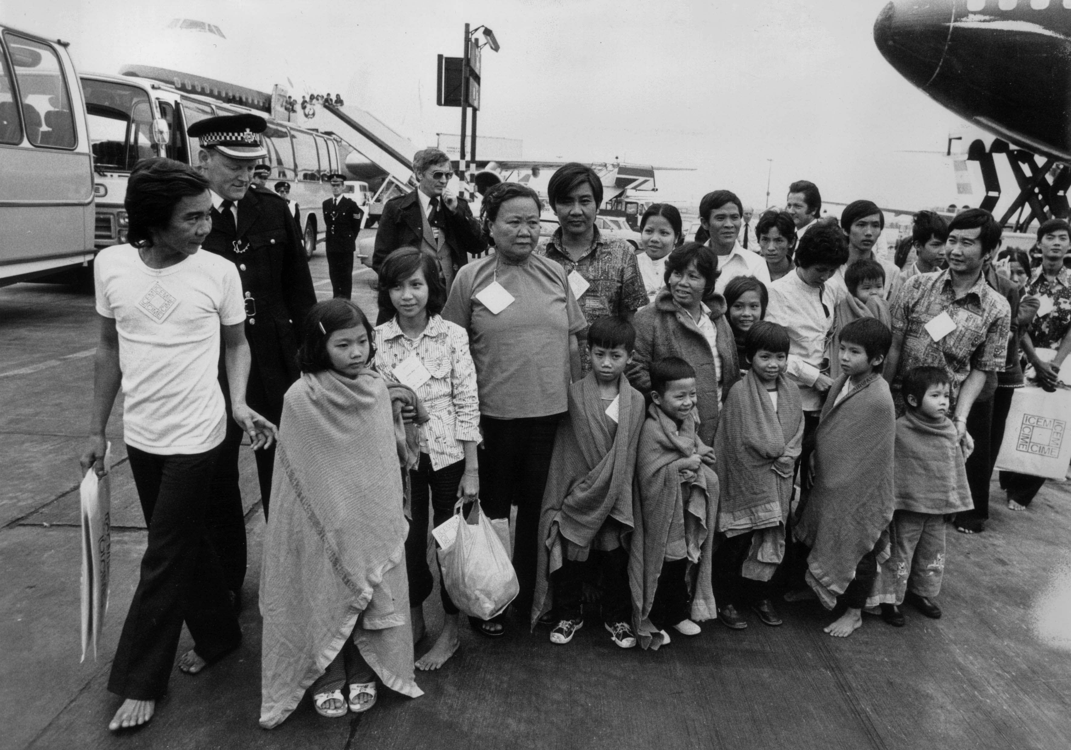 Boat people from Vietnam arrive in Britain in 1979. The children wear blankets over their shoulders