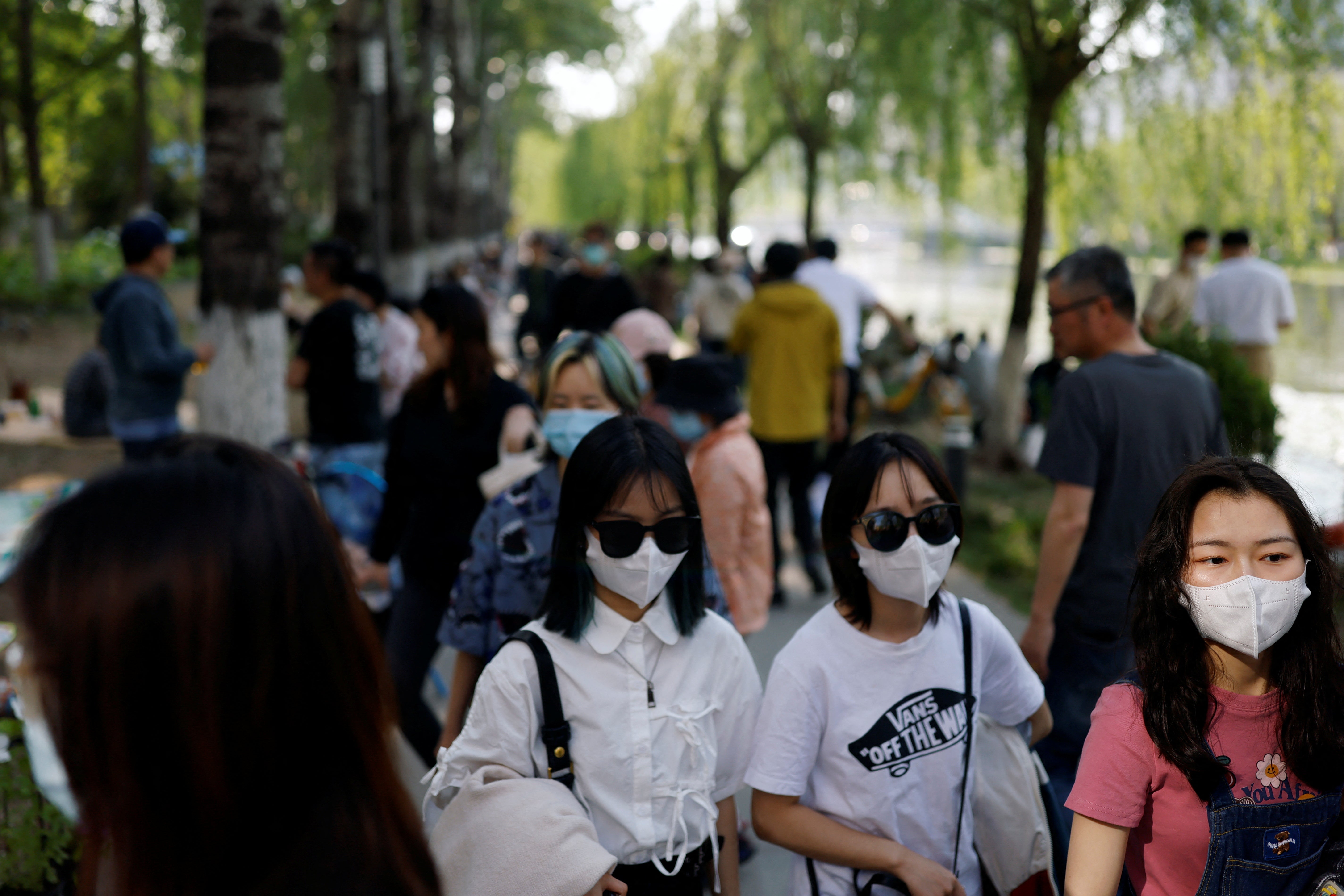 People enjoy the sun in a public park in Beijing amid a Covid-19 outbreak