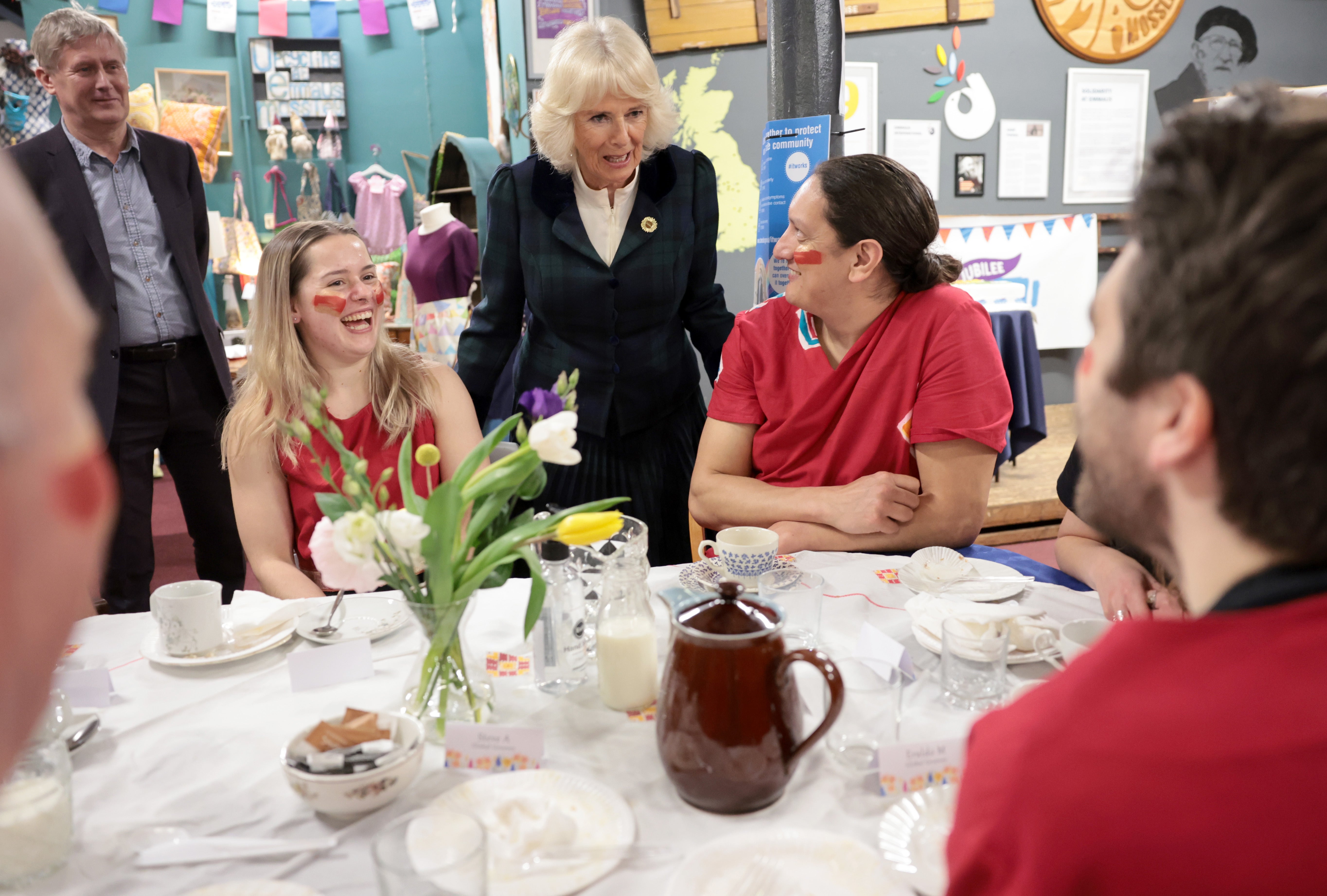 The Duchess of Cornwall, patron of both The Big Lunch and Emmaus UK, speaks with carnival performers (Chris Jackson/PA)