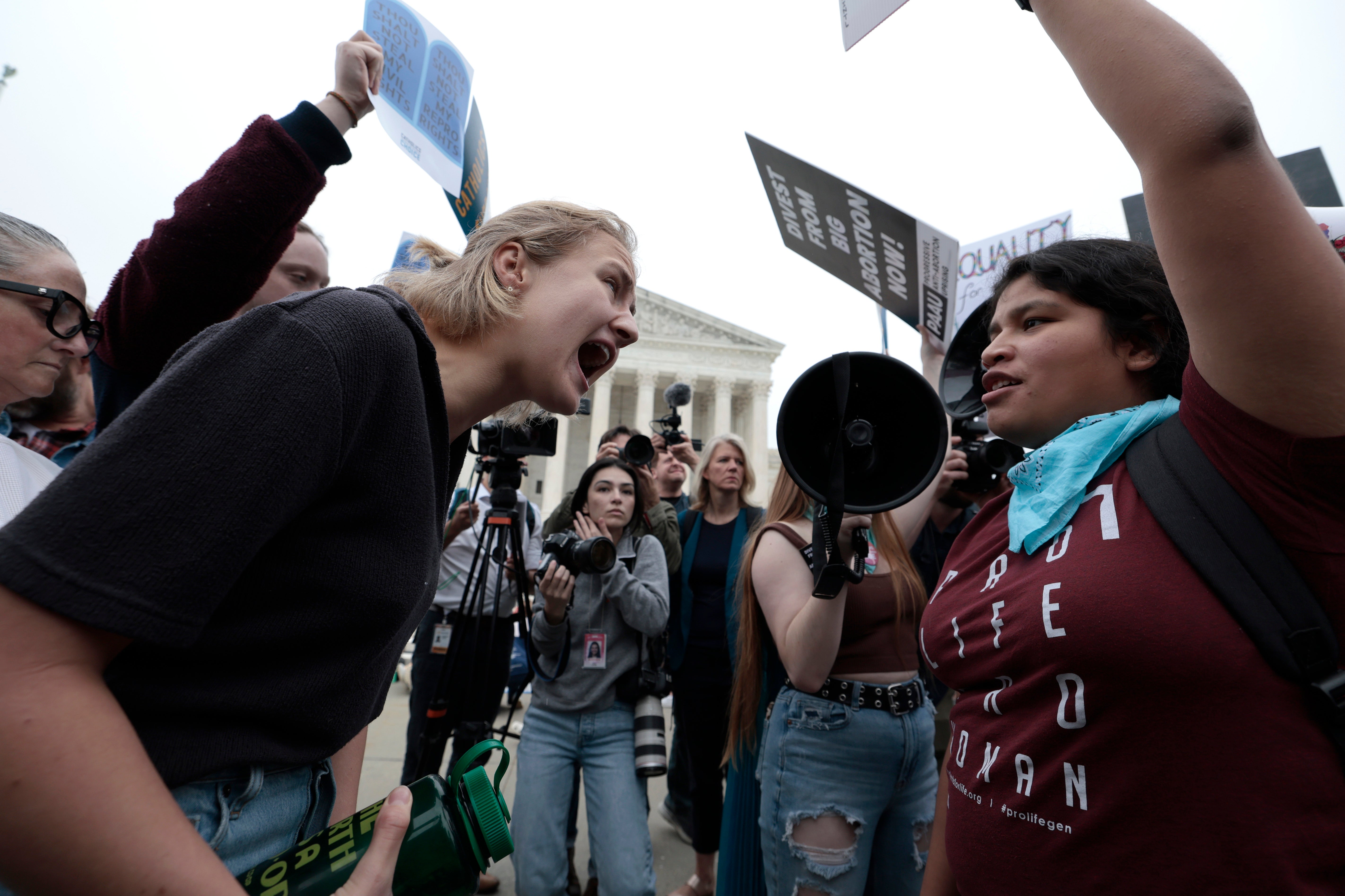 Activists on both sides demonstrate outside the Supreme Court