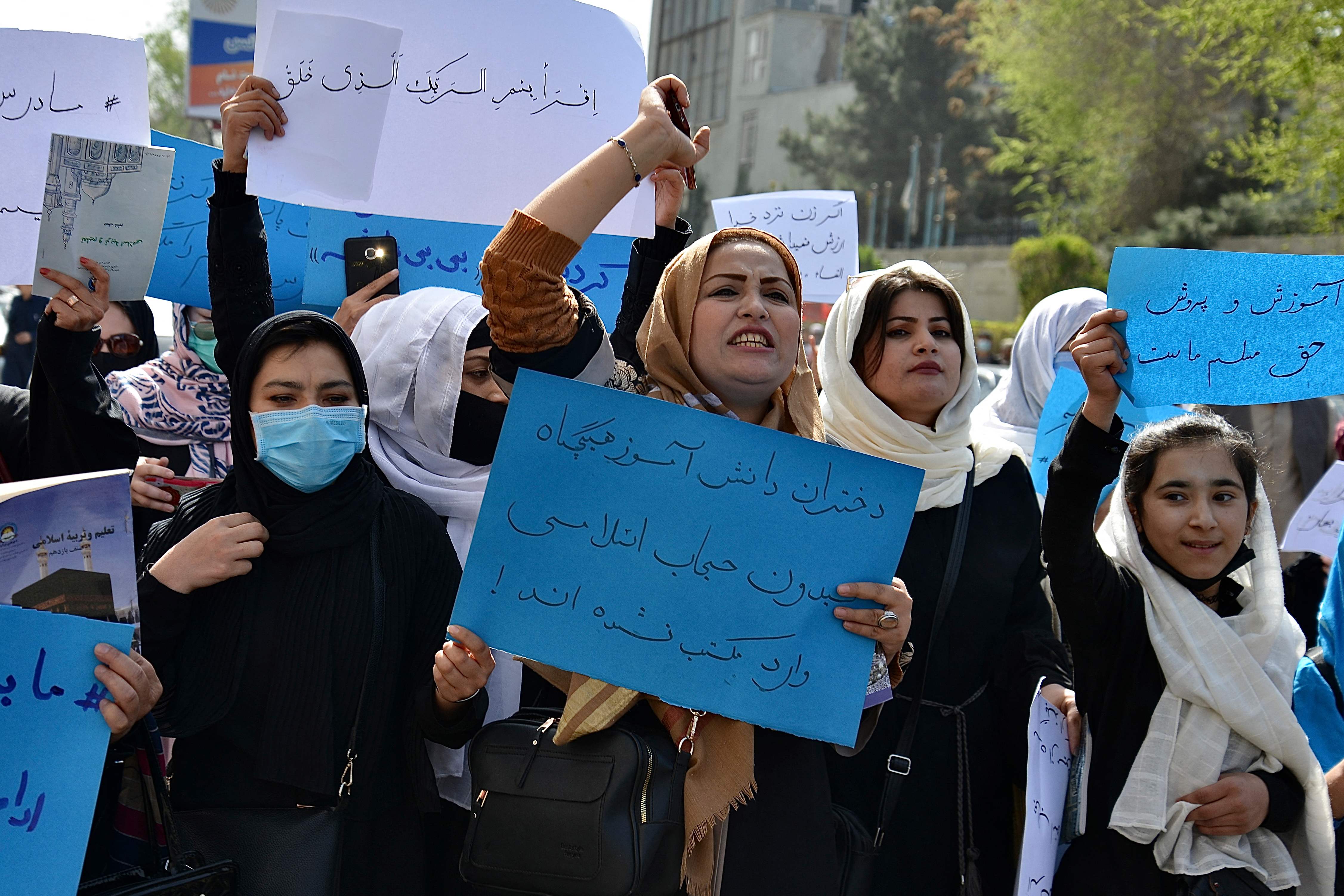 Afghan women and girls shout slogans demanding the reopening of high schools for girls during a demonstration in front of the Ministry of Education in Kabul