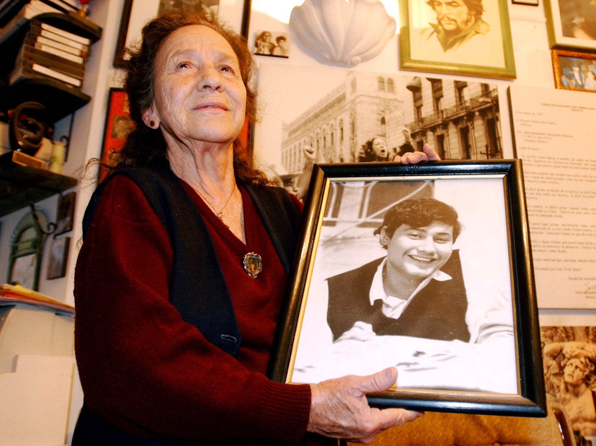 The activist holds a photo of her son, Jesus, who was last seen in 1975