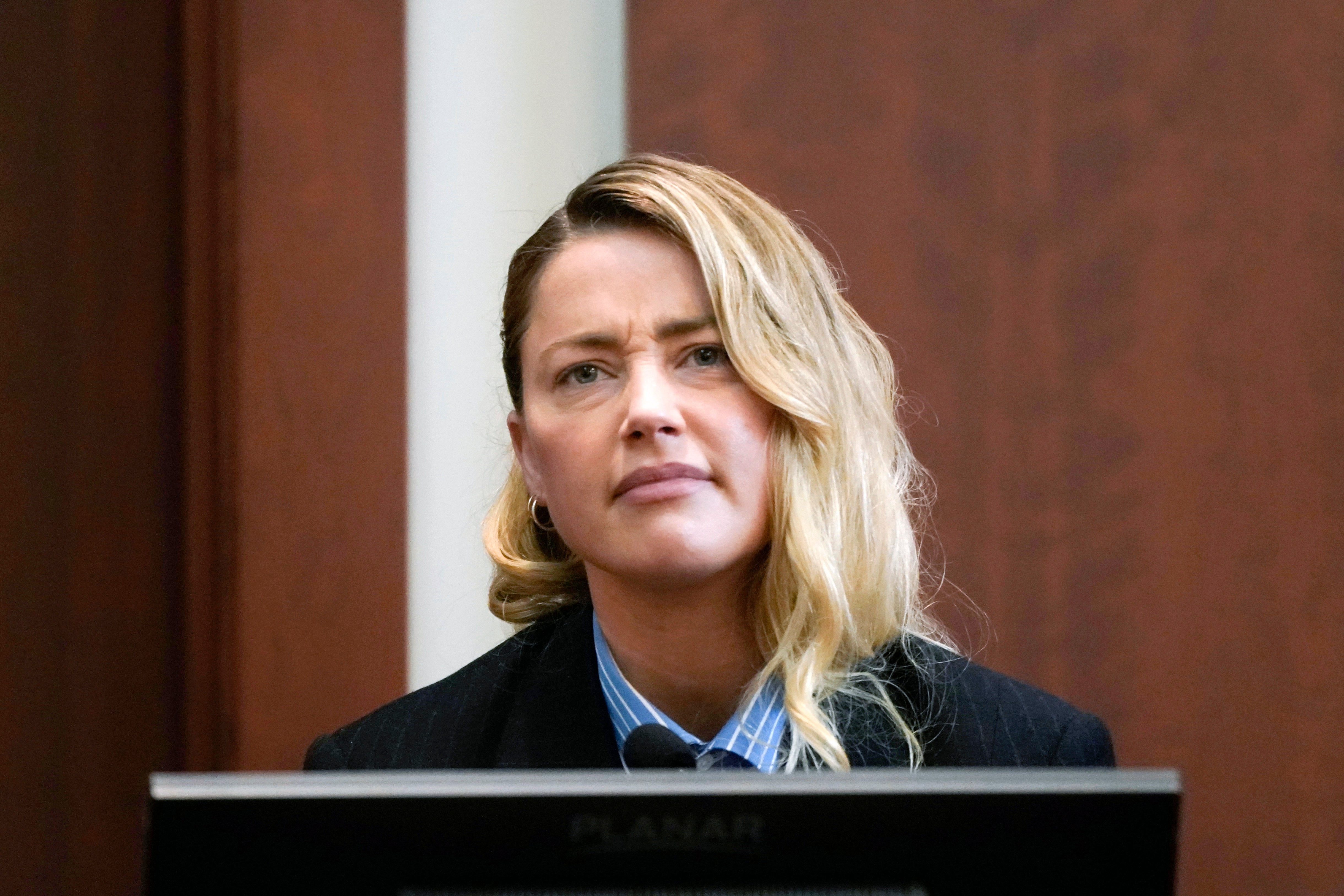 Actor Amber Heard reacts as she testifies at the Fairfax County Circuit Court in Fairfax, Va., Wednesday May 4, 2022