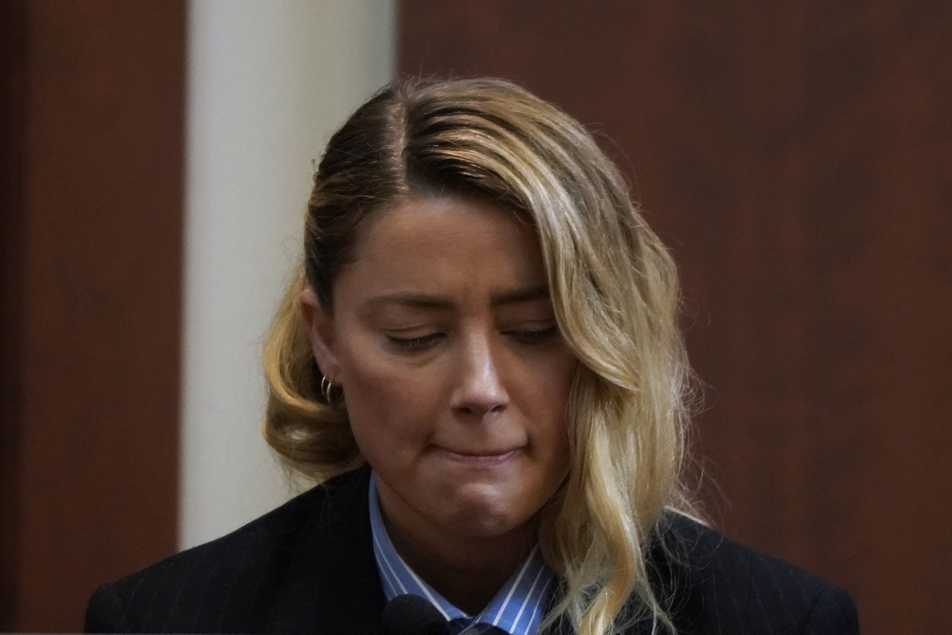 Actress Amber Heard reacts as she testifies during the Depp v Heard defamation case at Fairfax County Circuit Court, in Fairfax, Virginia, USA, 04 May 2022