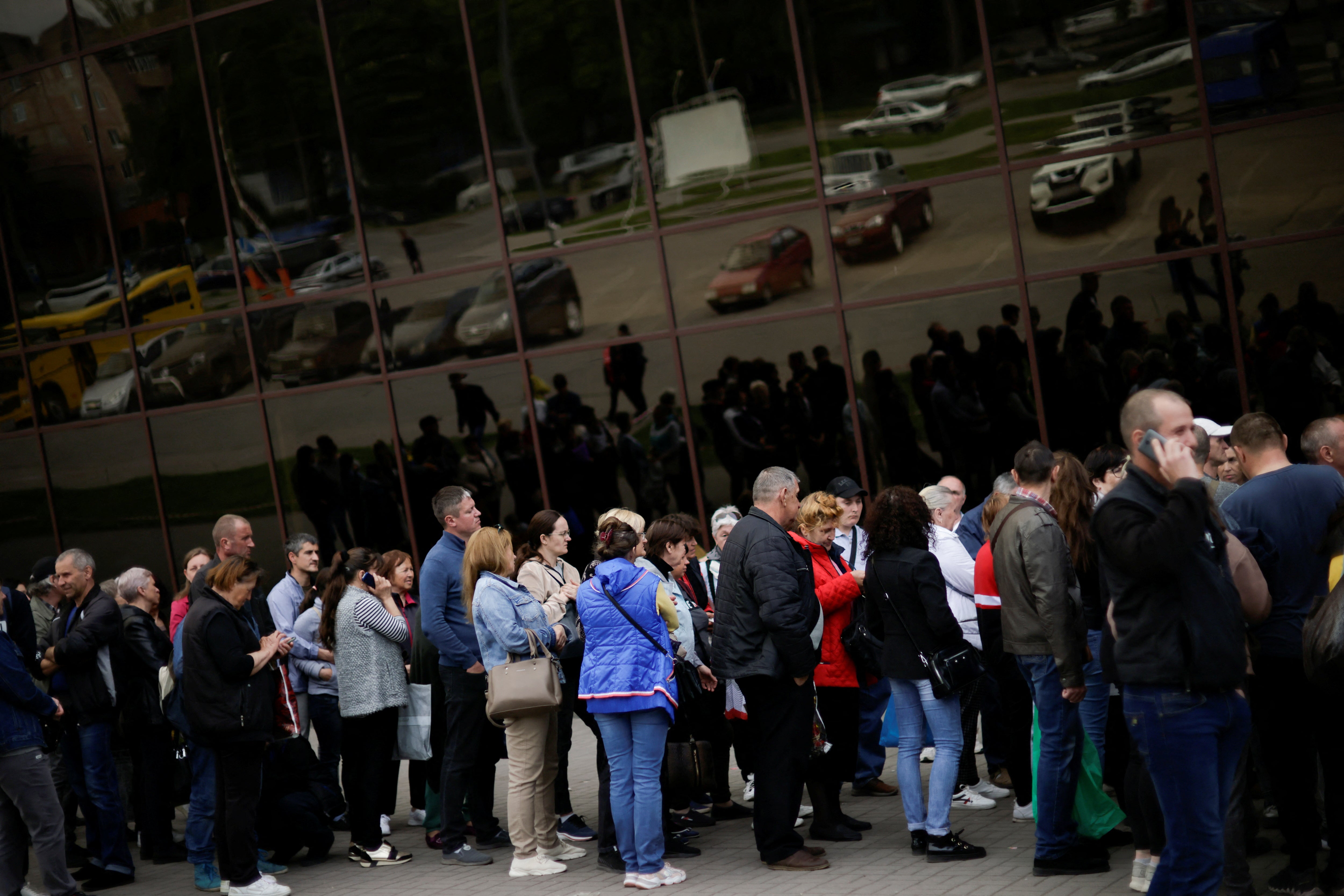 Ukrainian evacuees queue for aid at a donation collection point in Zaporizhzhia