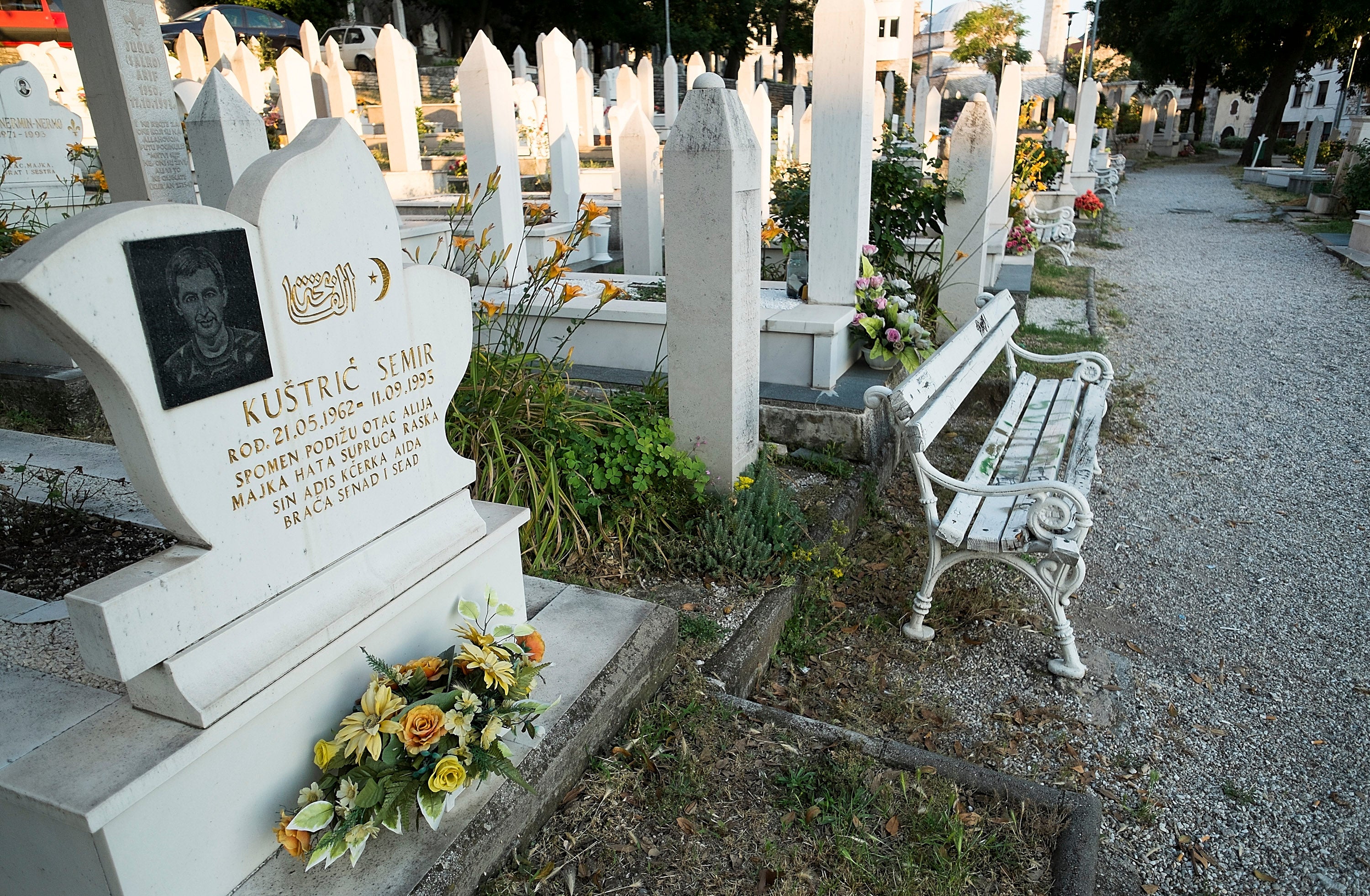 Flowers are placed on graves in a cemetery where victims of the 1993 siege rest