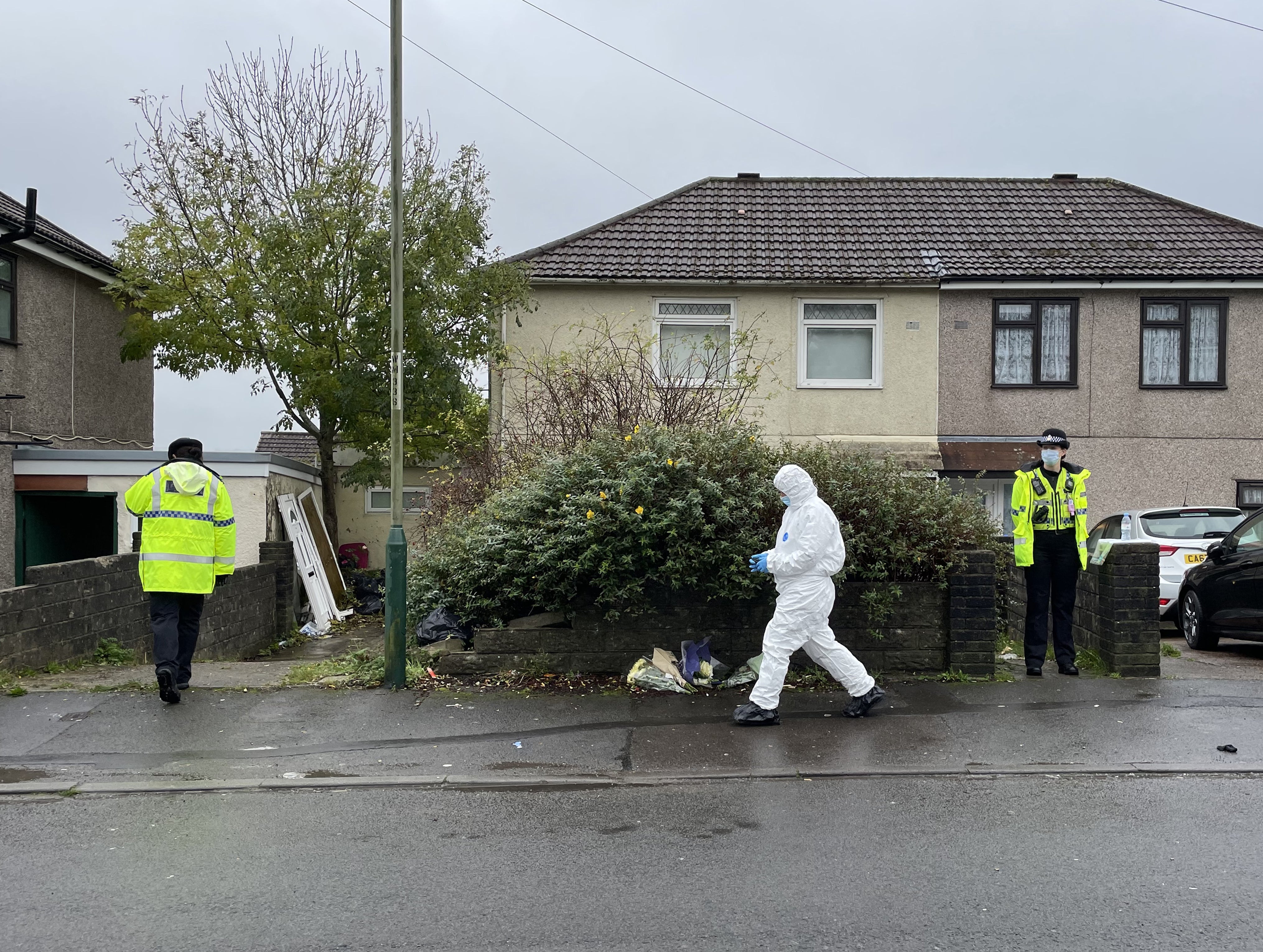 Flowers left outside the house where Jack Lis was killed (PA)