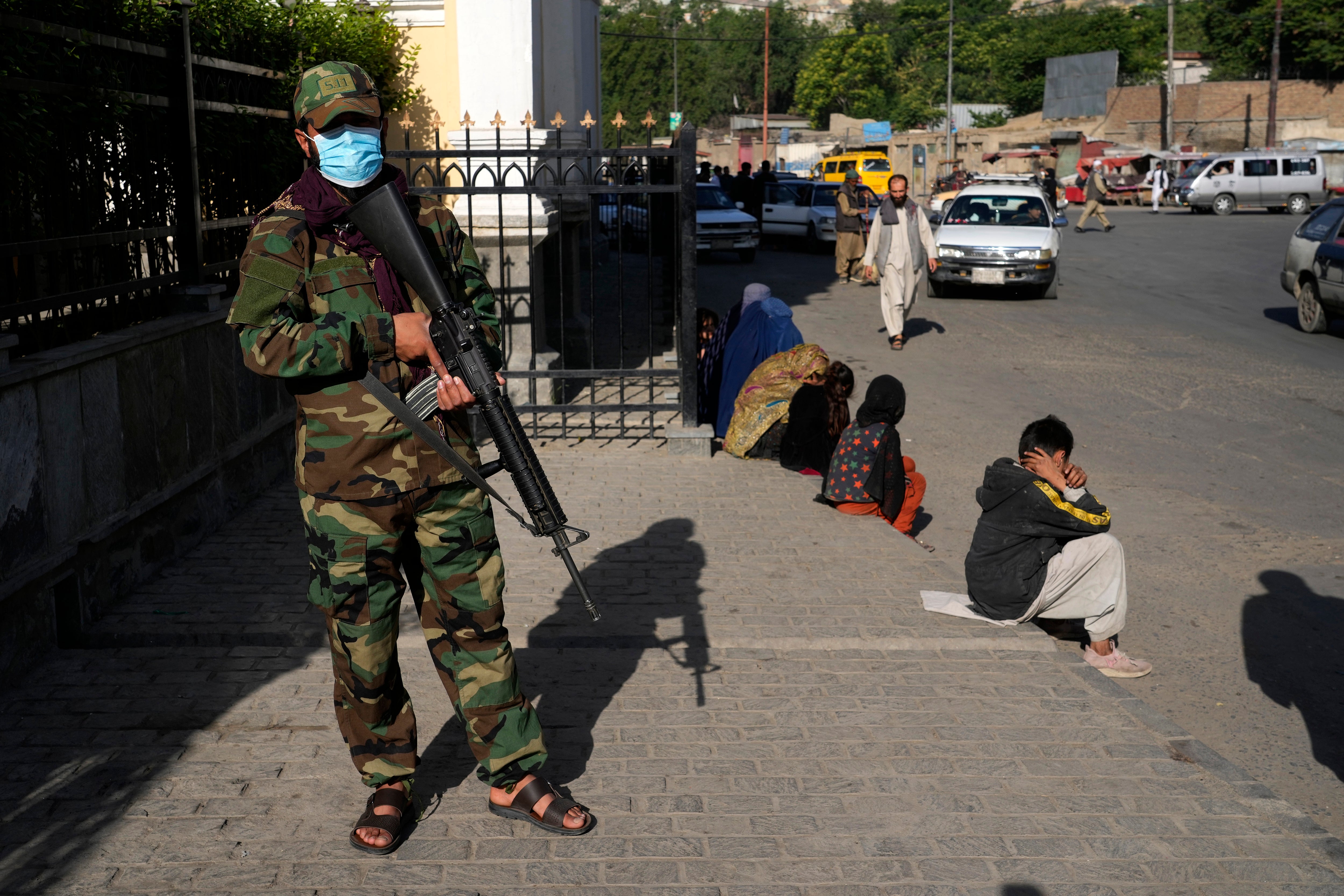 A Taliban fighter stands guard in front of a mosque at the first day of Eid al-Fitr in Kabul