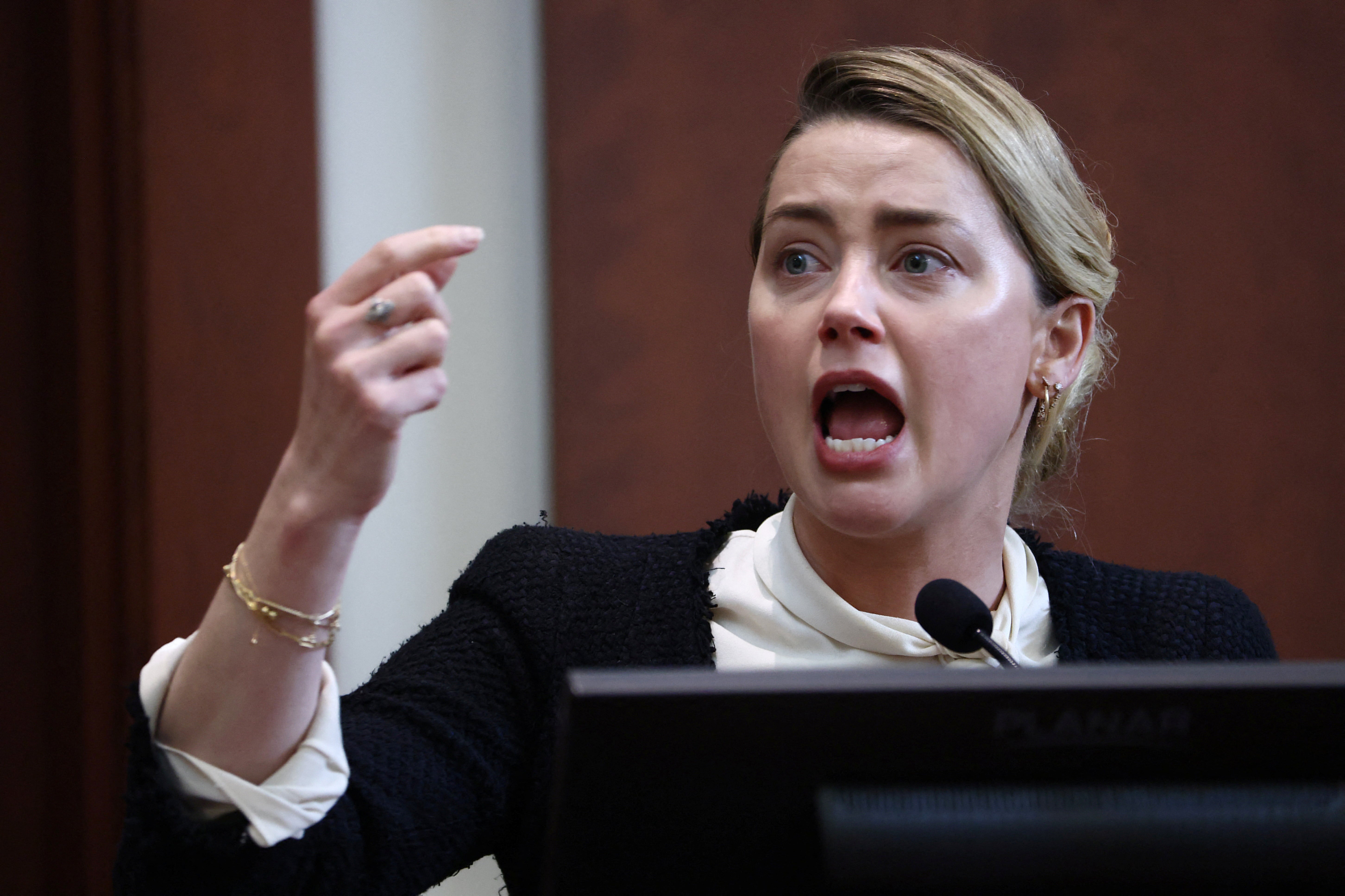 Actor Amber Heard reacts on the stand in the courtroom at Fairfax County Circuit Court during a defamation case against her by ex-husband, actor Johnny Depp, in Fairfax, Virginia, U.S., May 5, 2022