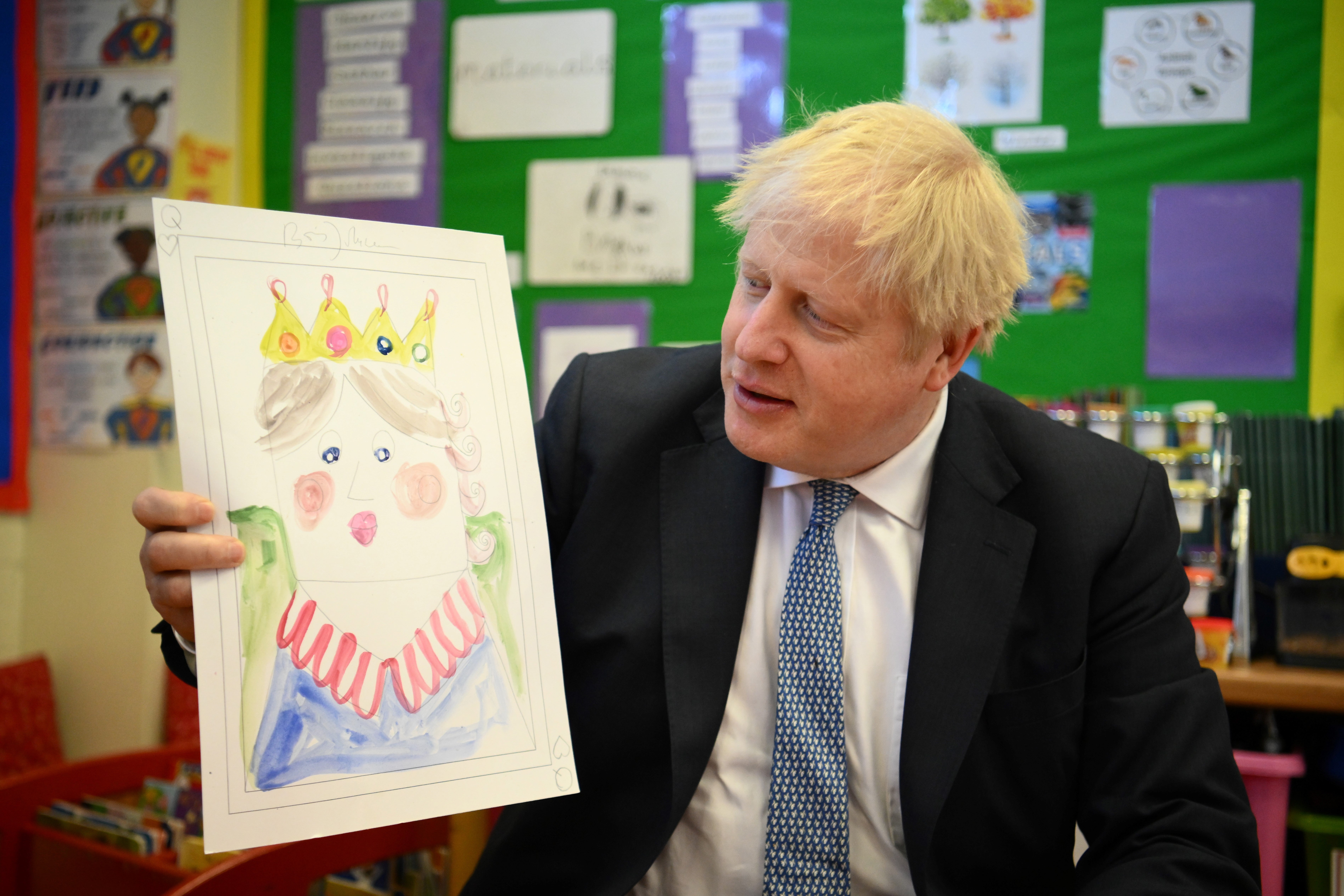 Boris Johnson with the portrait he painted of the Queen during a visit to Field End Infant School in South Ruislip